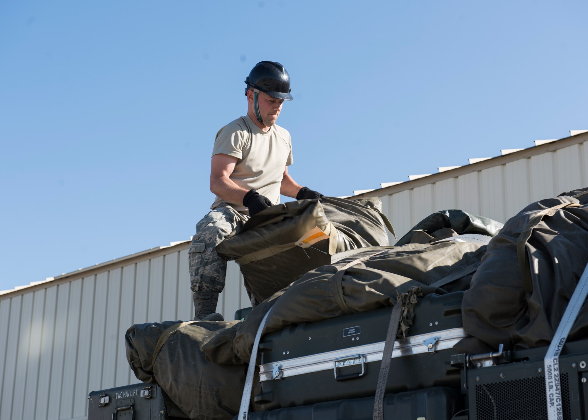 SrA Jordan Jones, 726th Air Control Squadron, loads equipment onto a Medium Tactical Vehicle July 11, 2019, at Mountain Home Air Force Base, Idaho. The cargo is being loaded in preparation for a 726th ACS deployment exercise. (U.S. Air Force Photo by Senior Airman Tyrell Hall)