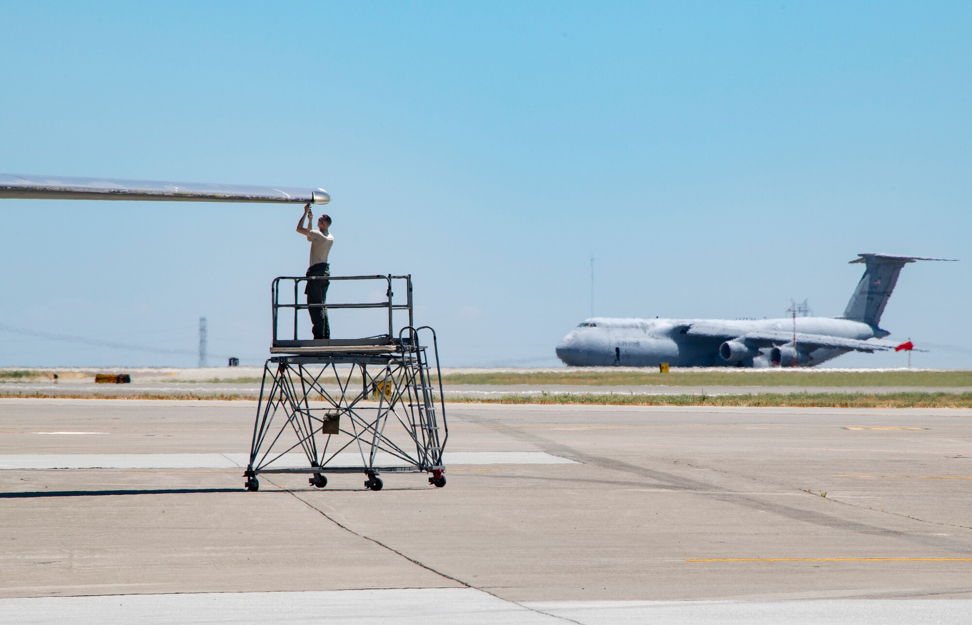 U.S. Air Force Airman 1st Class Joseph Galizia, 660th Aircraft Maintenance Squadron flying crew chief, works on the wing of a KC-10 Extender July 11, 2019, at Travis Air Force Base, California. The 660th AMXS provides combat-ready maintenance personnel and organizational support to inspect, service, and repair all transit and assigned KC-10A aircraft. (U.S. Air Force photo by Heide Couch)