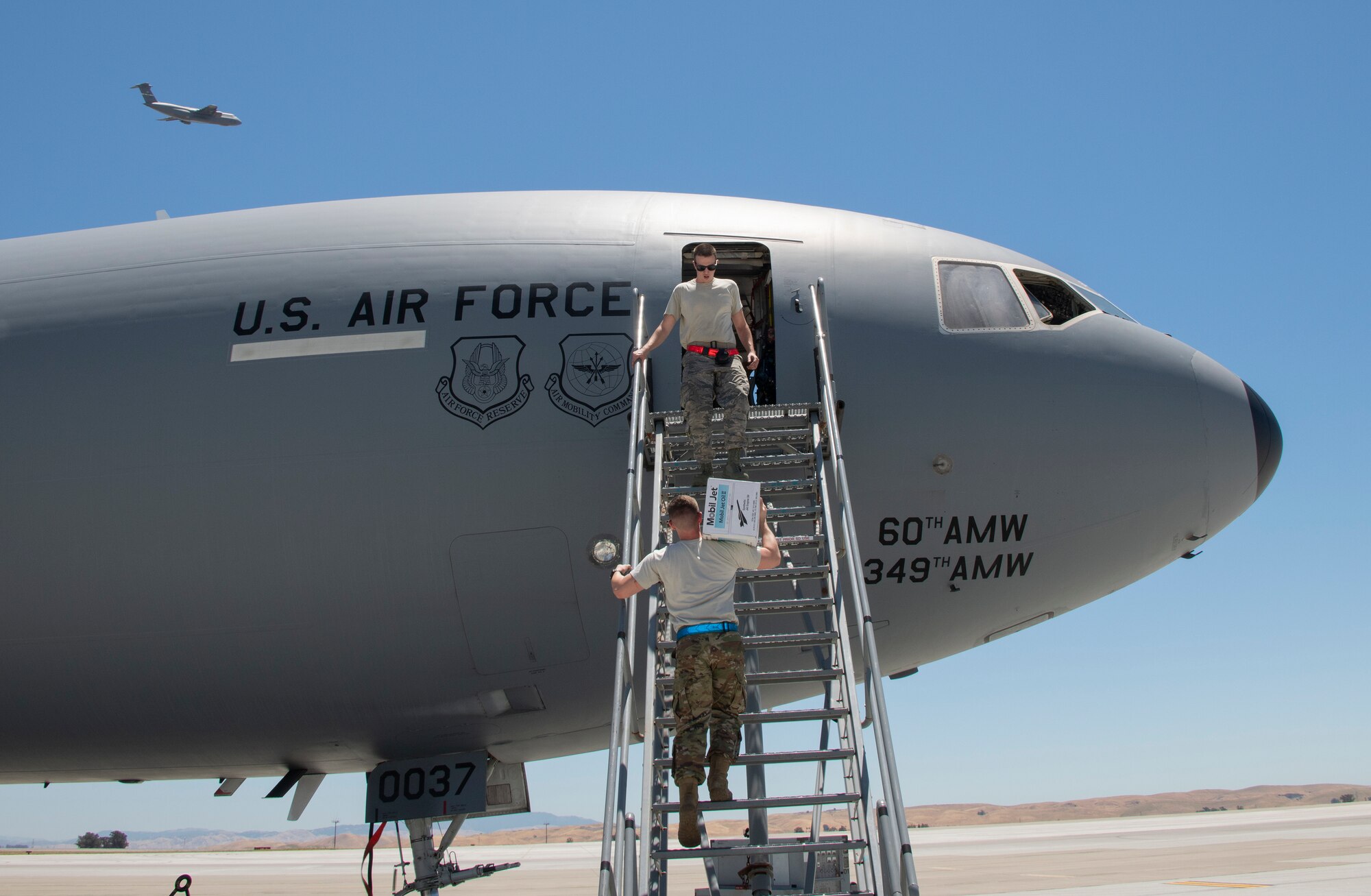 U.S. Air Force flying crew chiefs assigned to the 660th Aircraft Maintenance Squadron, load supplies onto a KC-10 Extender prior to takeoff July 11, 2019, at Travis Air Force Base, California. FCCs are responsible for a wide variety of maintenance duties while traveling with the aircraft including refueling, paperwork, routine maintenance and troubleshooting major issues. (U.S. Air Force photo by Heide Couch)