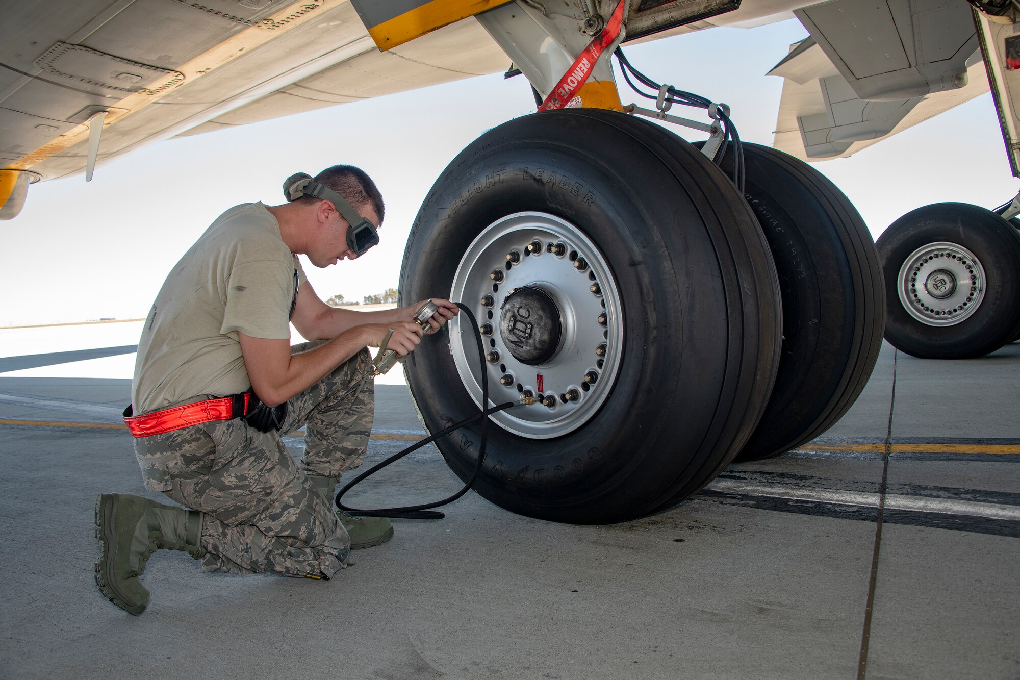U.S. Air Force Senior Airman John Phoebus, 660th Aircraft Maintenance Squadron aero propulsion apprentice, checks the tire pressure on a KC-10 Extender prior to takeoff July 11, 2019, at Travis Air Force Base, California. Under supervision, Phoebus temporarily undertook the extra responsibilities of a flying crew chief to fill a mission requirement. FCCs are responsible for a wide variety of maintenance duties while traveling with the aircraft including refueling, paperwork, routine maintenance and troubleshooting major issues. (U.S. Air Force photo by Heide Couch)