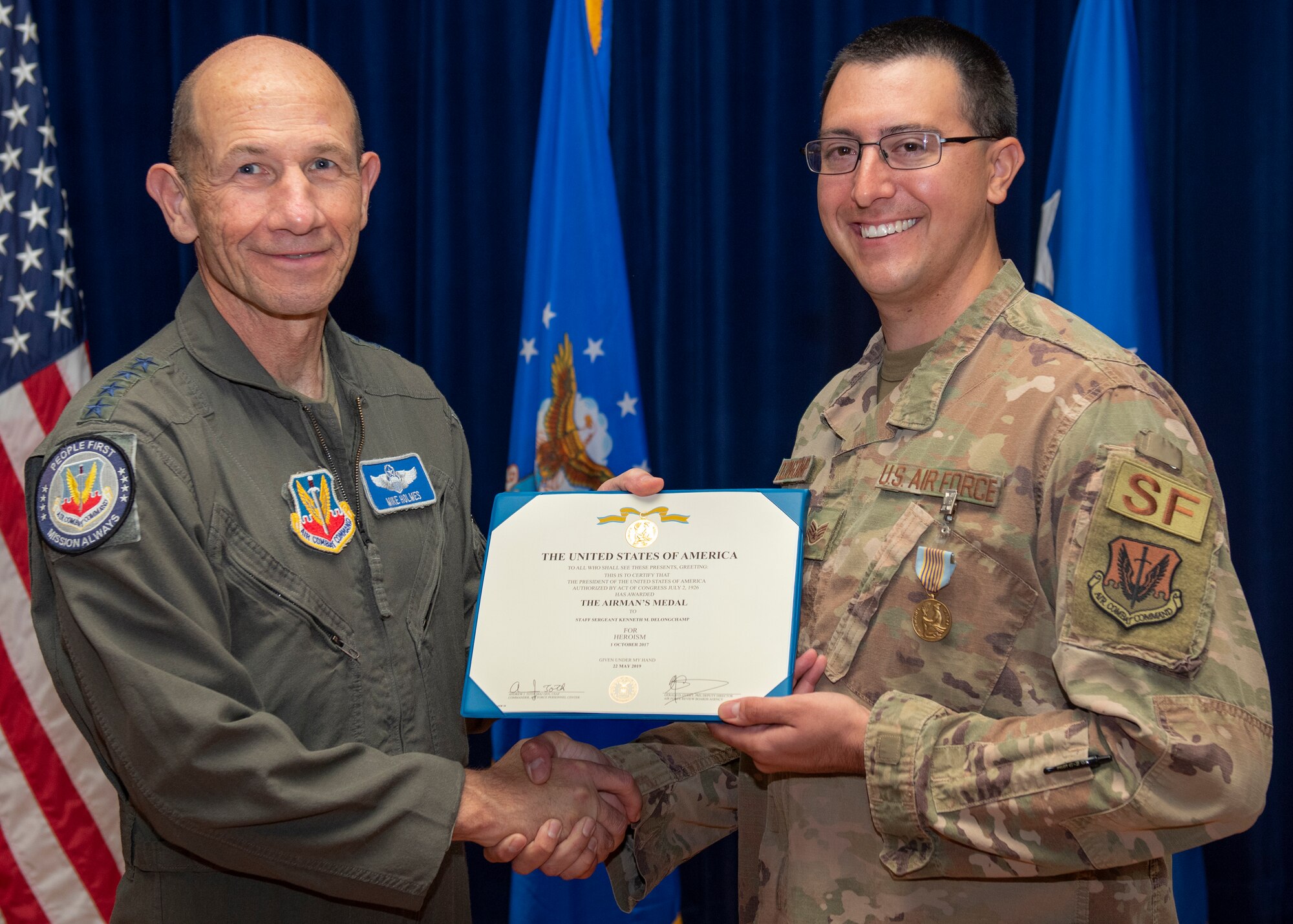 Gen. Mike Holmes and Staff Sgt. Kenneth Delongchamp pose for a photo.