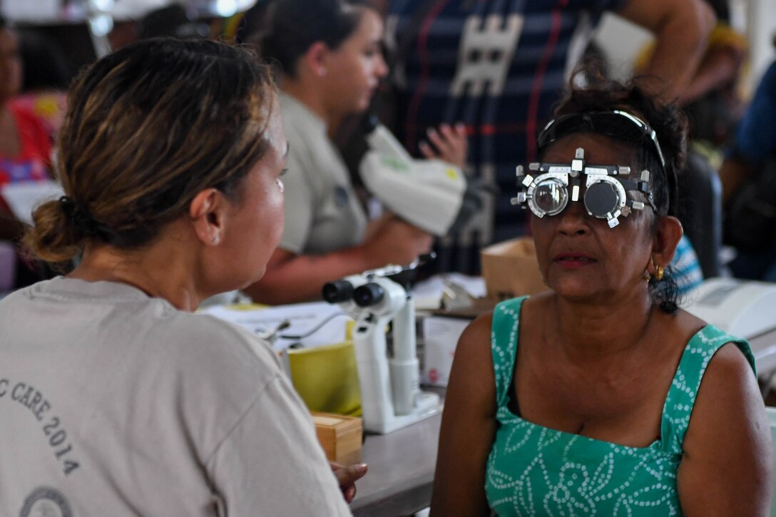 An optometrist examines a patient.