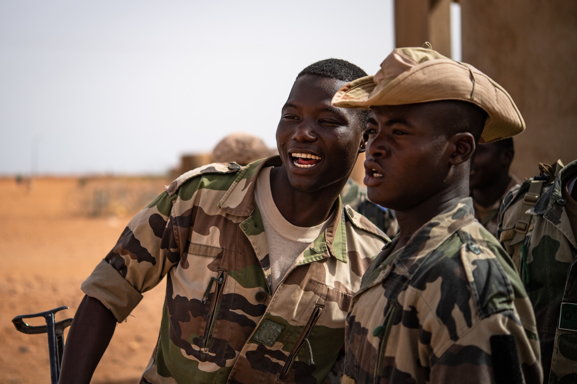 Niger Armed Forces (French language: Forces Armées Nigeriennes) members sing and dance while on break during a training exercise with the 409th Expeditionary Security Forces Squadron air advisors at the FAN compound on Nigerien Air Base 201 in Agadez, Niger, July 10, 2019. The FAN sing and dance every training day to keep their morale high. (U.S. Air Force photo by Staff Sgt. Devin Boyer)