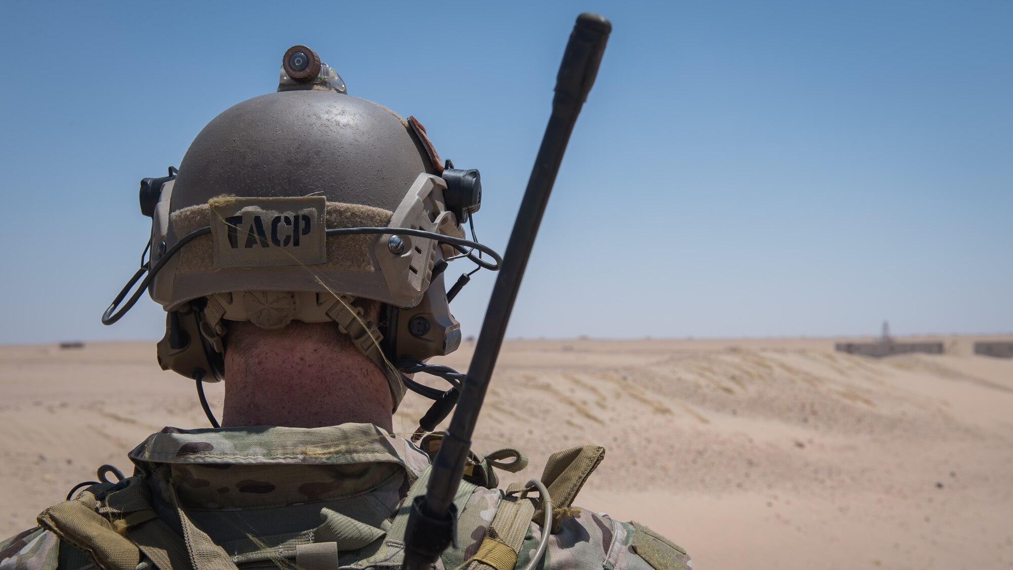 A Tactical Air Control Support (TACP) Specialist Airman with the 820th Expeditionary Air Support Operations Squadron, surveys the landscape during medical evacuation training at Camp Buehring, Kuwait, July 12, 2019. Airmen from the 386th Expeditionary Medical Group, stationed at Ali Al Salem Air Base, Kuwait, trained with TACP's to become more efficient at treating injuries and coordinating medevac efforts for casualties. (U.S. Air Force photo by Tech. Sgt. Daniel Martinez)