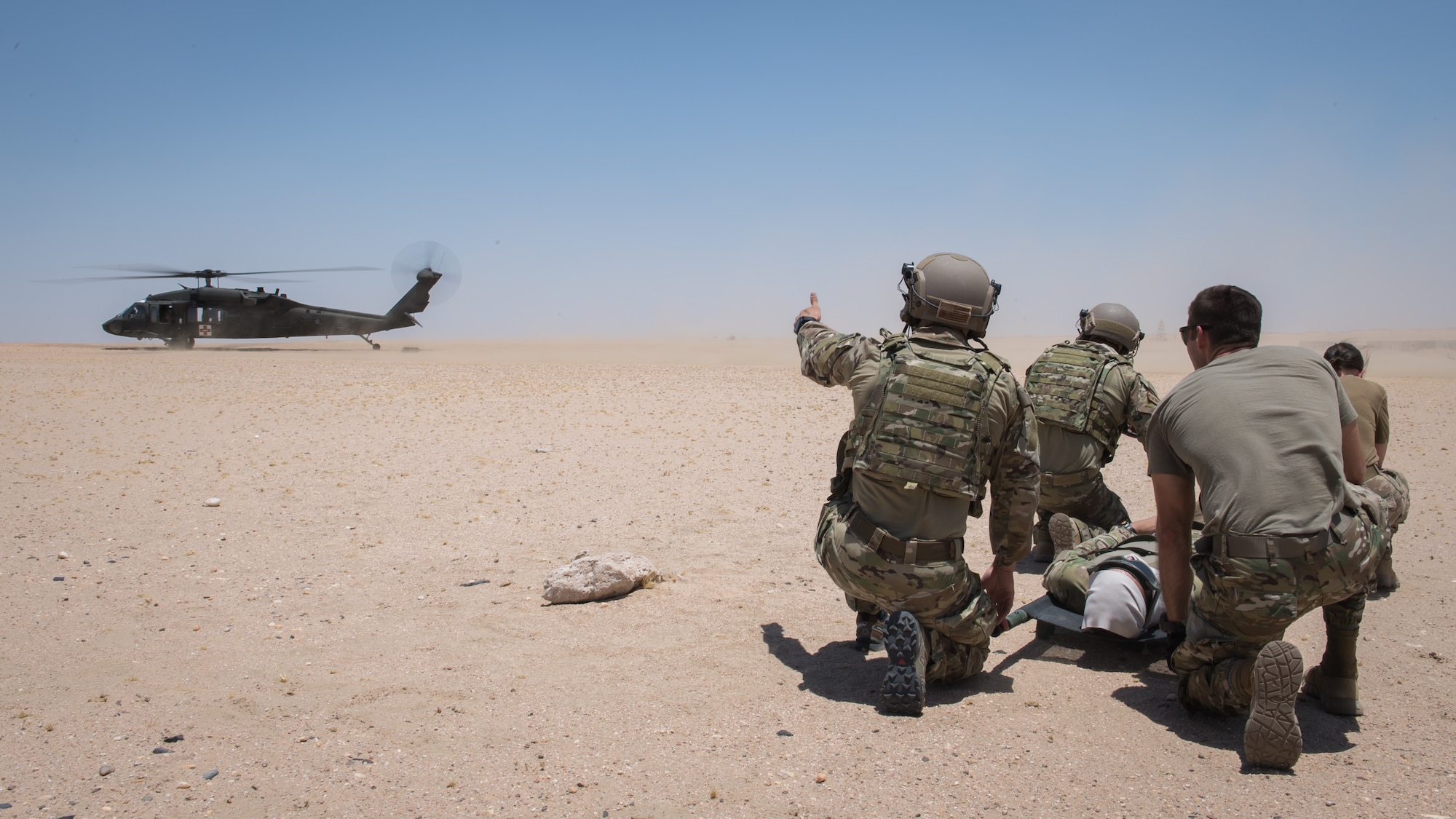 Tactical Air Control Support (TACP) Airmen with the 820th Expeditionary Air Support Operations Squadron, exericse a medical evacuation scenario with Airmen from the 386th Expeditionary Medical Group during a training scenario at Camp Buehring, Kuwait, July 12, 2019. Medical and TACP Airmen trained together to hone their skills and become more efficient at treating injuries and coordinating medevac efforts for casualties. (U.S. Air Force photo by Tech. Sgt. Daniel Martinez)