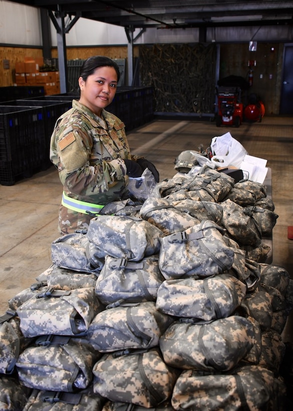 Tech Sgt. Audrey Palacios, the 932nd Material Management Section non commissioned officer in charge, looks over bags in the supply line July 13, 2019 at Scott Air Force Base, Ill.  "This helps pre-check equipment that will allow unit deployment managers to assist their people checking into the DCC (Deployment Control Center)," said Palacios.  The inspection events started July 12 and continued through the July 13-14 Unit Training Assembly.   (U.S. Air Force photo by Lt. Col. Stan Paregien)