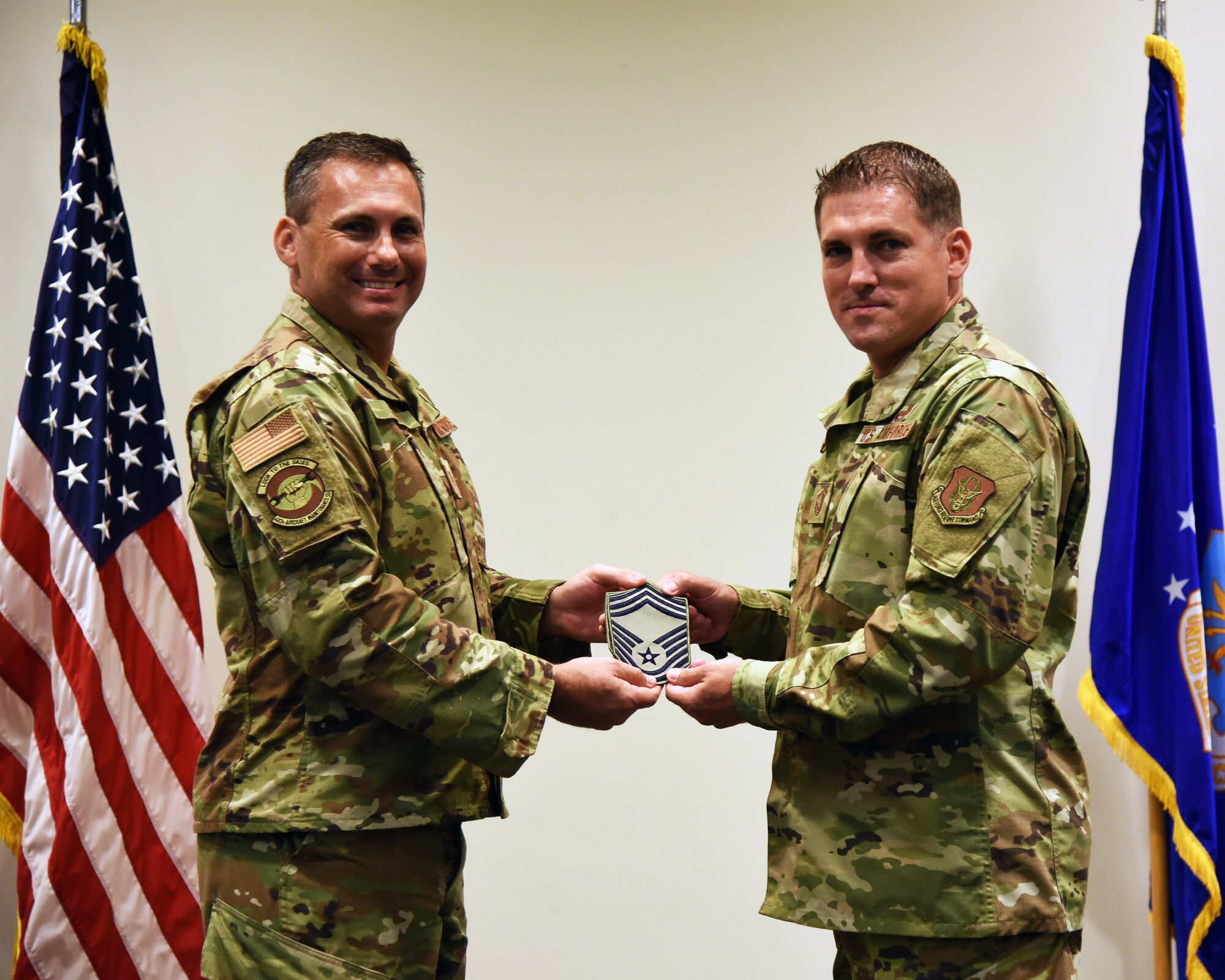 Thomas Lassabe, 403rd Aircraft Maintenance Squadron, receives his chief master sergeant stripes from Maj. Kelly Soich, 403rd AMXS commander, during a promotion ceremony held at the Roberts Consolidated Maintenance Facility July 13, 2019, Keesler Air Force Base, Mississippi. (U.S. Air Force photo by Tech. Sgt. Christopher Carranza)