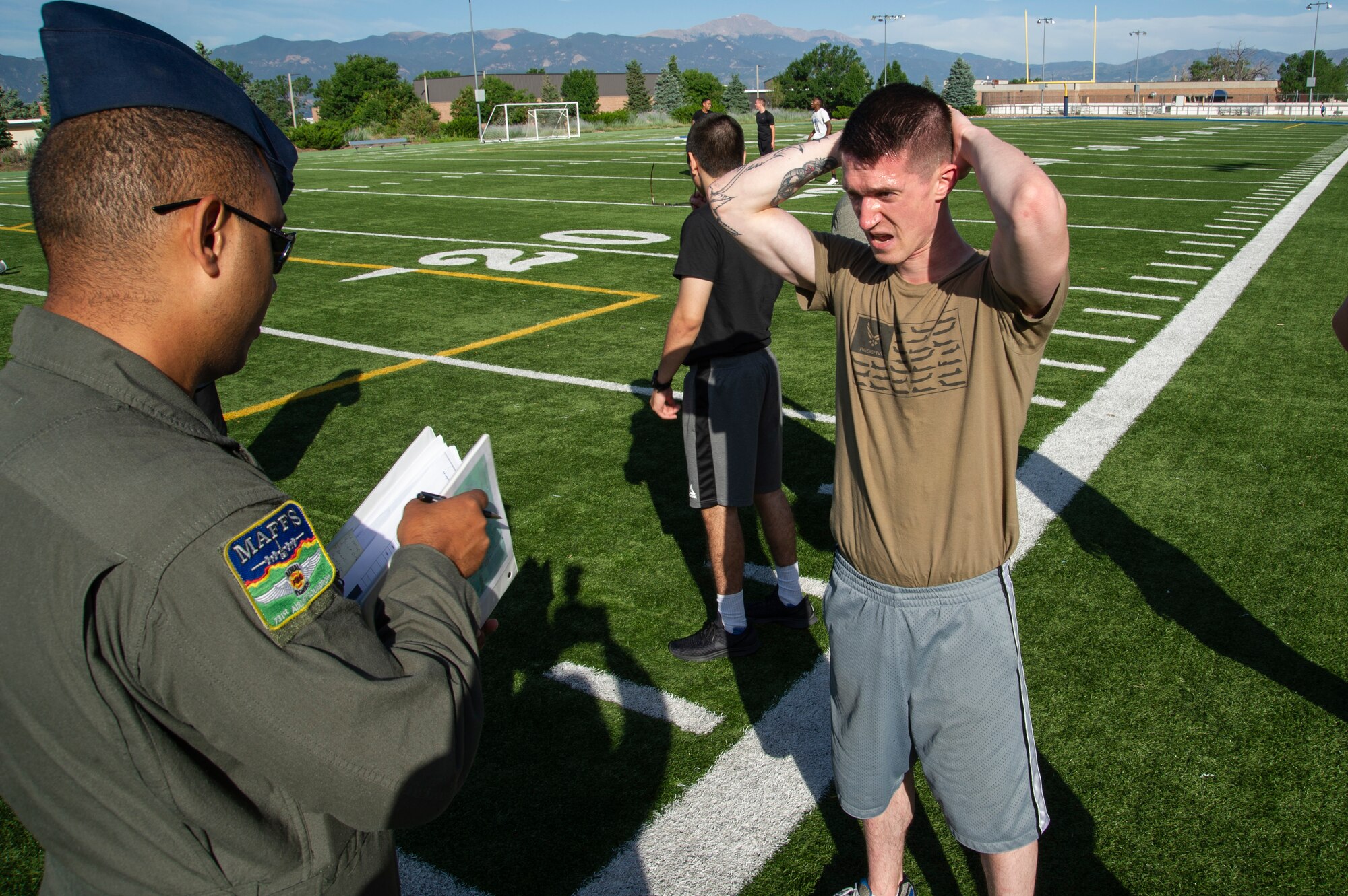 Tech. Sgt. Joshua Winn, 302nd Airlift Wing Development and Training Flight program manager, speaks to a trainee July 14, 2019 at Peterson Air Force Base, Colorado. Winn leads the flight in physical training and teaches them military structure, customs and courtesies and Air Force history so they are prepared for basic military training. (U.S. Air Force photo by Tech. Sgt. Amber Sorsek)