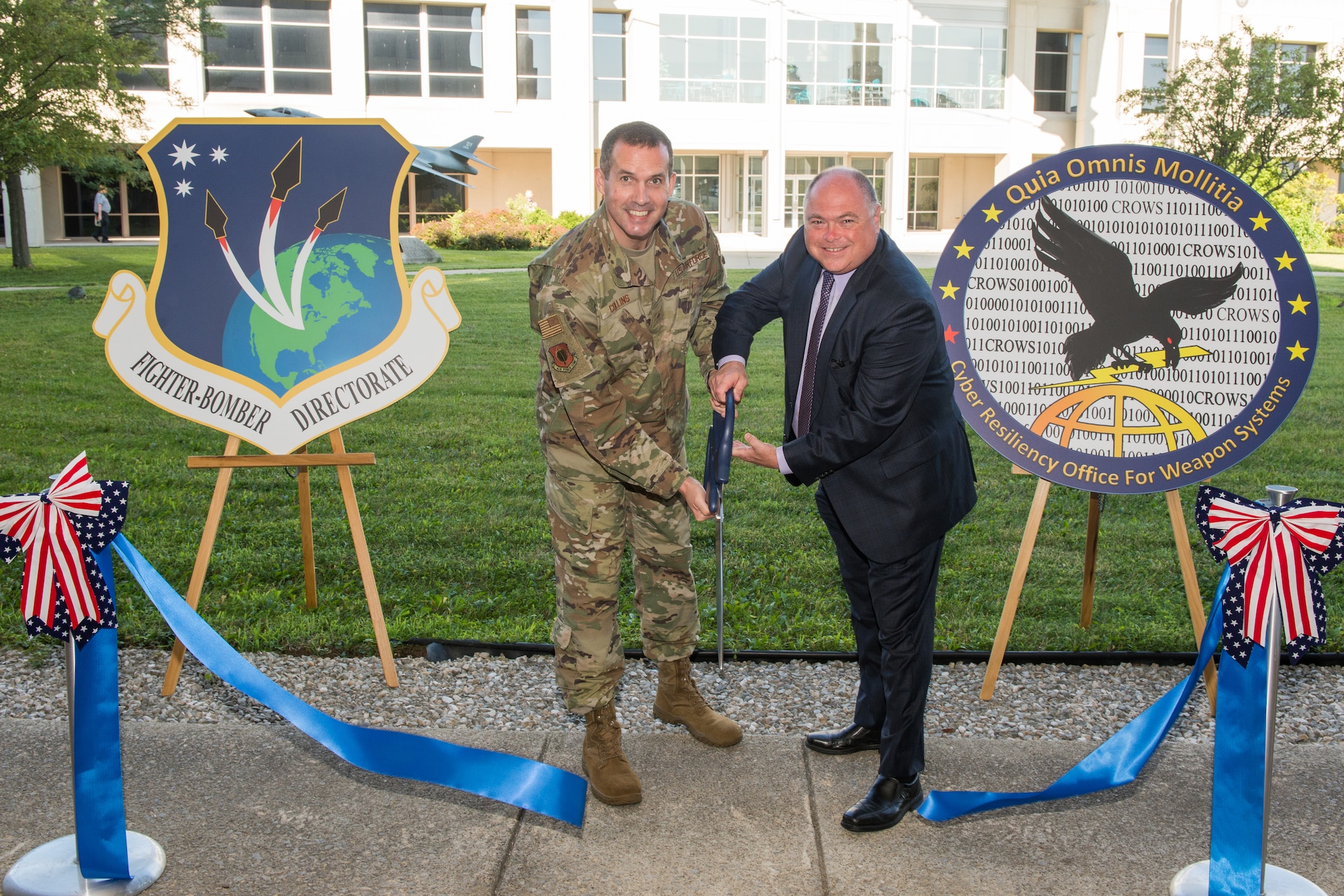 Brig. Gen. Heath Collins, Program Executive Officer for Fighters and Bombers and Joseph Bradley, director for CROWS, officially open a cyber defense facility for the Fighters and Bombers Directorate. (U.S. Air Force photo / Wesley Farnsworth)