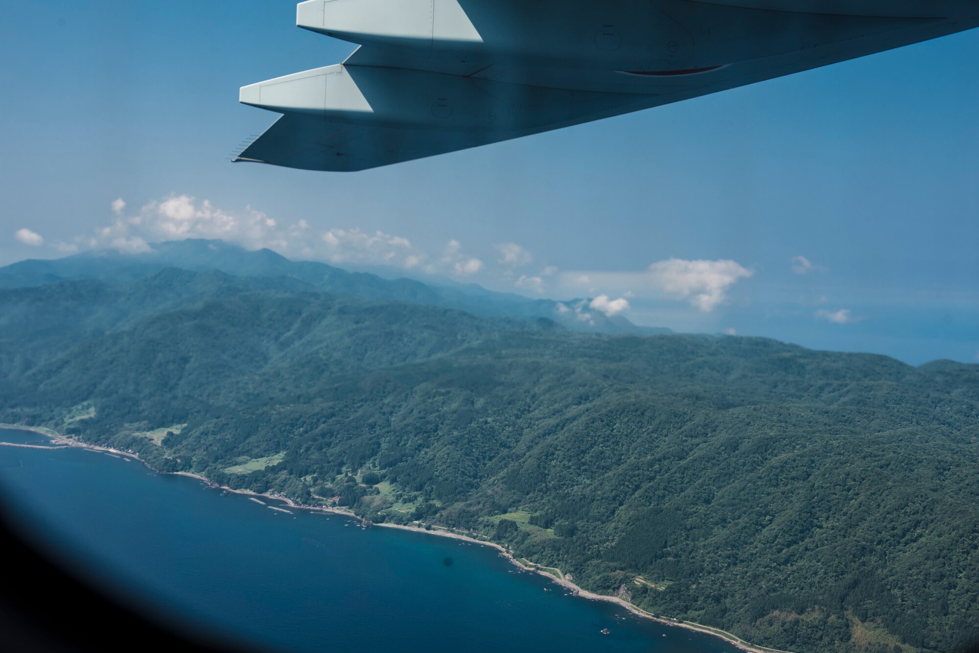 The view from the inside of a C-2 assigned to Japan Air Self-Defense Force, 3rd Tactical Airlift Wing, 403rd Squadron, as it flies over Sado island, Japan, during a bilateral airlift exchange July 10, 2019.