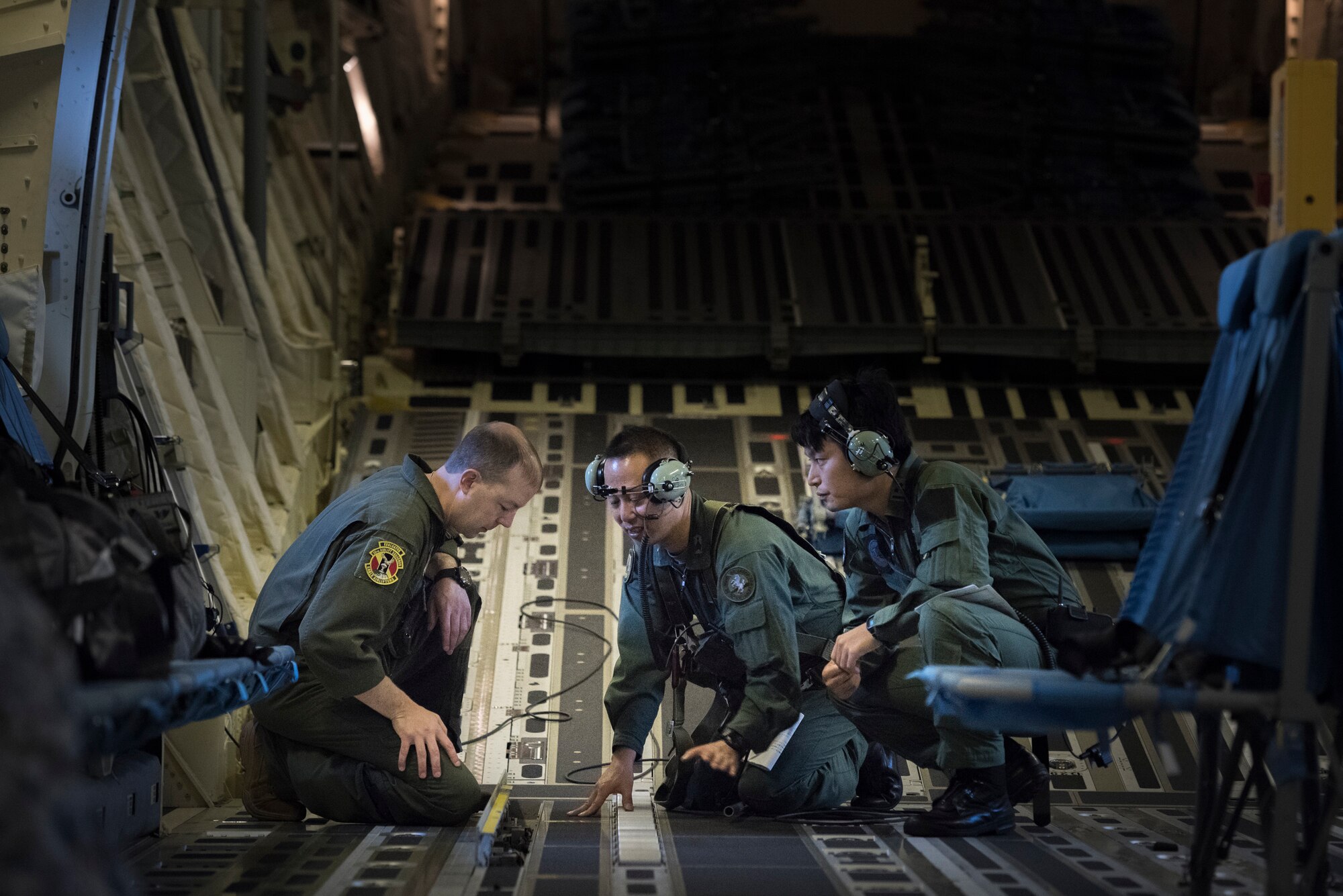 A members from the Japan Air Self-Defense Force answer questions from Master Sgt. Michael McArty, 36th Airlift Squadron flight chief and C-130J evaluator, during a bilateral airlift exchange over Chubu region, Japan, July 10, 2019.