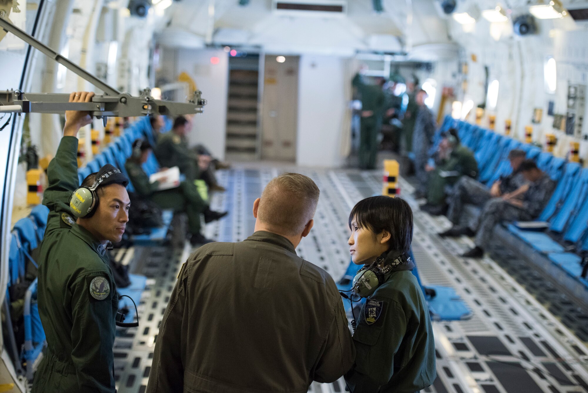 Master Sgt. James Huntsman, 36th Airlift Squadron flight chief and C-130J instructor loadmaster, converses with aircrew members from Japan Air Self-Defense Force during a bilateral airlift exchange over Chubu region, Japan, July 10, 2019.