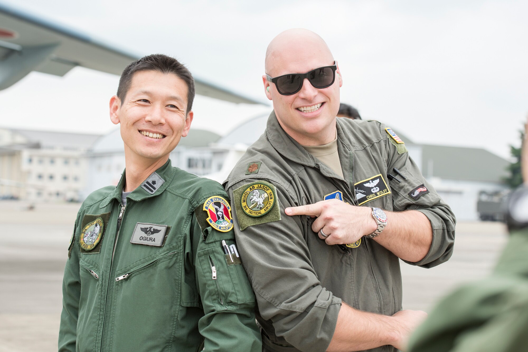 Major Christopher Wolff, 36th Airlift Squadron assistant director of operations, and a member of the Japan Air Self-Defense Force pose for a photo after trading patches during a bilateral airlift exchange at Iruma Air Base, Japan, July 10, 2019.