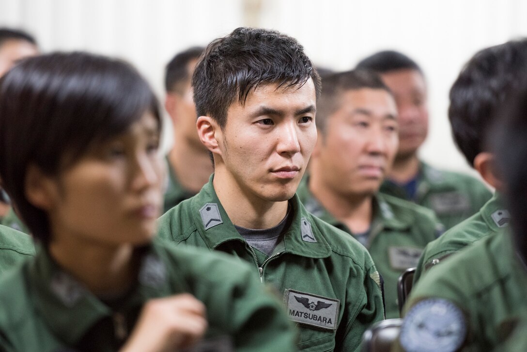 A members from the Japan Air Self-Defense Force listens to a brief during a bilateral airlift exchange at Iruma Air Base, Japan, July 10, 2019.
