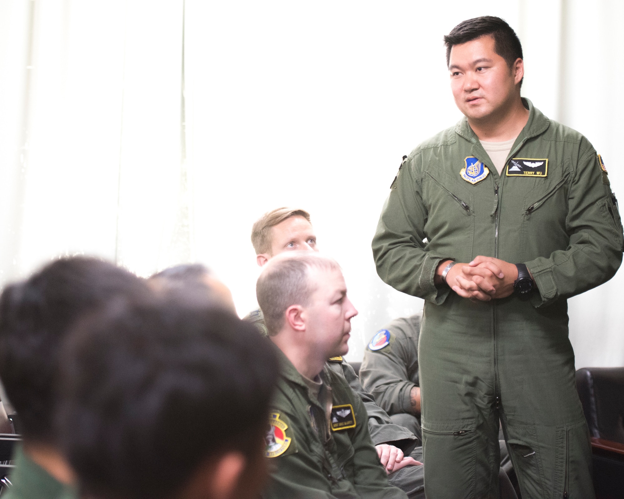 Capt. Terry Wu, 36th Airlift Squadron C-130J instructor pilot, answers a question from a member of the Japan Air Self-Defense Force after the briefing during a bilateral airlift exchange at Iruma Air Base, Japan, July 10, 2019