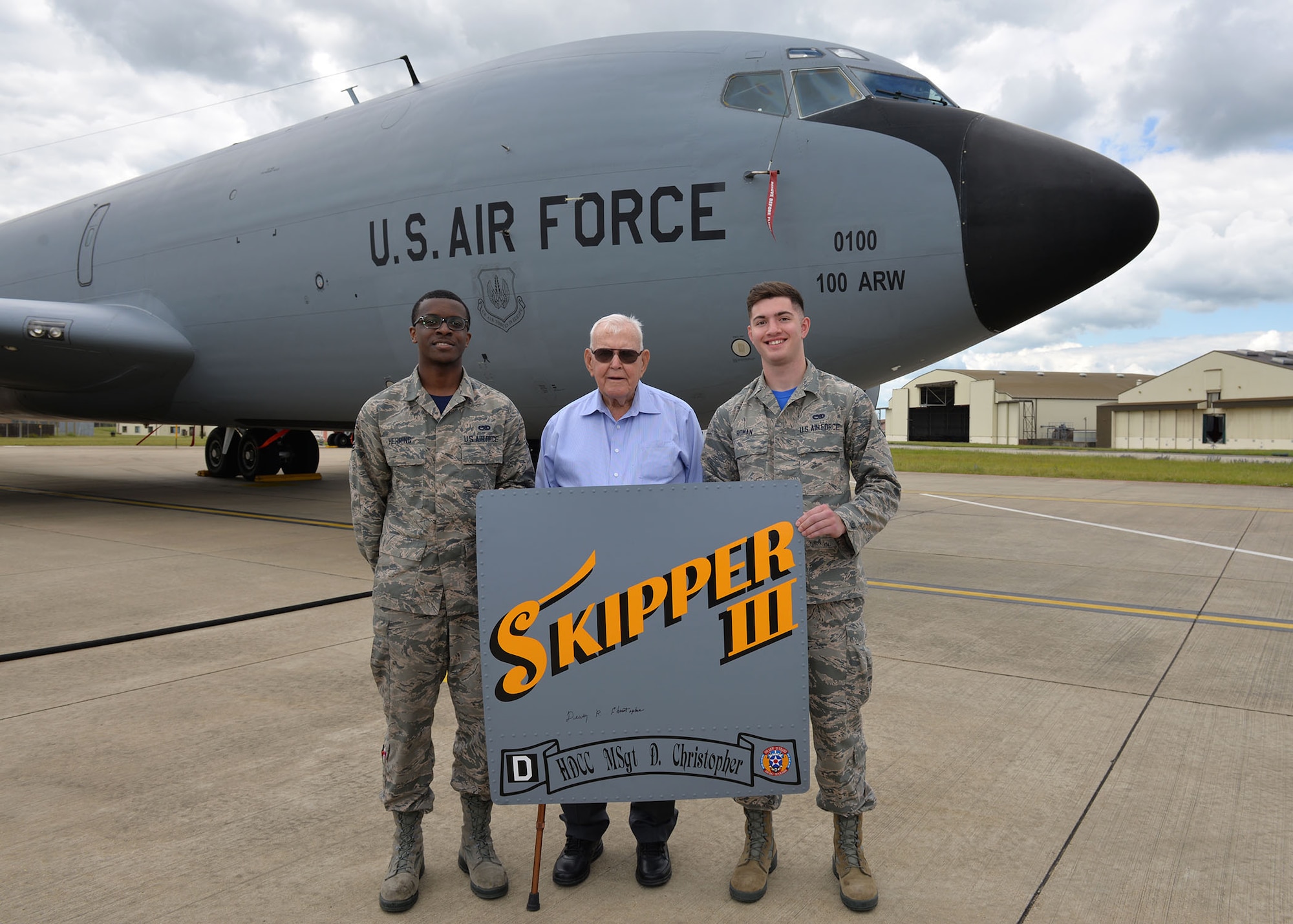 U.S. Air Force Airman 1st Class Isaiah Herring, left, 100th Aircraft Maintenance Squadron maintainer, and U.S. Air Force Airman Camden Roman, 100th Maintenance Squadron maintainer, pose for a photo with retired Master Sgt. Dewey Christopher, a former 351st Bomb Squadron crew chief, 100th Bomb Group and World War II veteran, during the veteran’s visit to RAF Mildenhall, England, June 21, 2019. Christopher visited the base to attend a renaming ceremony of the Professional Development Center in his honor. (U.S. Air Force photo by Karen Abeyasekere)