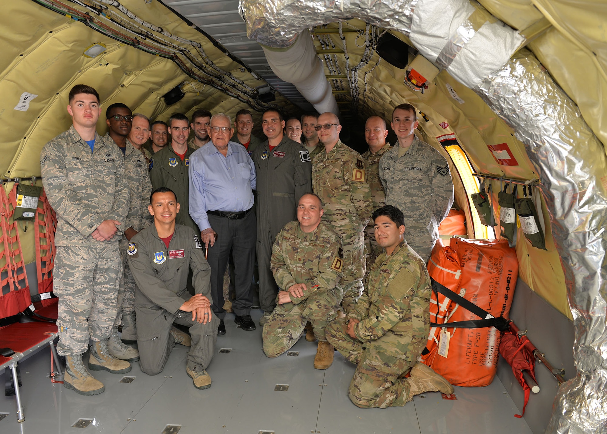 U.S. Air Force Airmen from the 100th Operations Group and 100th Maintenance Group pose for a photo with retired Master Sgt. Dewey Christopher, a former 351st Bomb Squadron crew chief, 100th Bomb Group and World War II veteran, when he visited RAF Mildenhall, England, June 21, 2019. The Professional Development Center was renamed the “Dewey R. Christopher Professional Development Center” to honor the legacy of the veteran, who was guest of honor at the event. (U.S. Air Force photo by Karen Abeyasekere)