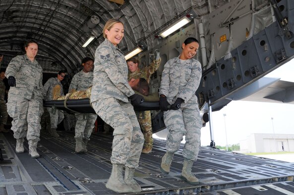 Airmen from the 445th Aeromedical Staging Squadron carry a “patient” down the ramp of a 445th Airlift Wing C-17 Globemaster III to an awaiting bus during a monthly training exercise here June 1, 2019