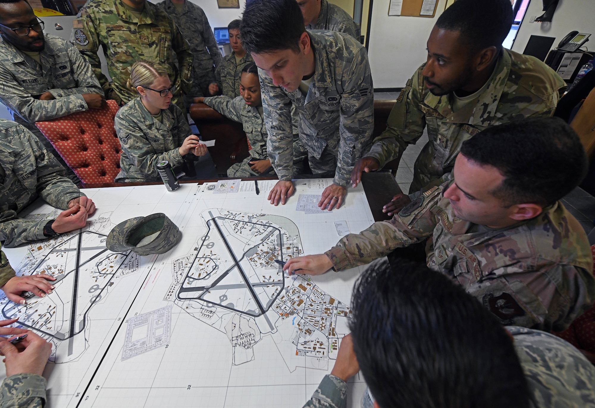 U.S. Air Force Staff Sgt. Arthur Singletary, 48th Logistics Readiness Squadron ground transportation operator, teaches Airmen from the 100th and 48th LRS navigation using a map during a Readiness Honed In Operations training day at RAF Lakenheath, England, July 13, 2019. Airmen received in-class training in conjunction with hands-on training such as to self-aid buddy care, advanced vehicle recovery using a tow truck and land navigation maps. (U.S. Air Force photo by Senior Airman Luke Milano)