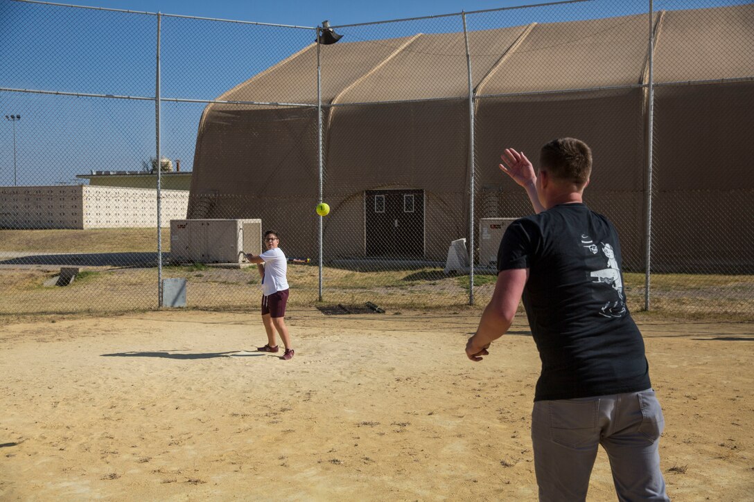 A U.S. Marine with Special Purpose Marine Air-Ground Task Force-Crisis Response-Africa 19.2, Marine Forces Europe and Africa, plays baseball with a student from La Inmaculada charter school during a community relations event on Moron Air Base, Spain, July 2, 2019.
