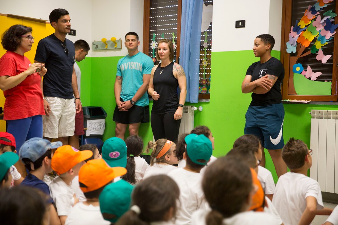 U.S. Marines with Special Purpose Marine Air-Ground Task Force-Crisis Response-Africa 19.2, Marine Forces Europe and Africa, introduce themselves to children at Parrocchia Di San Giuseppe in Mascali, Italy, July 3, 2019.