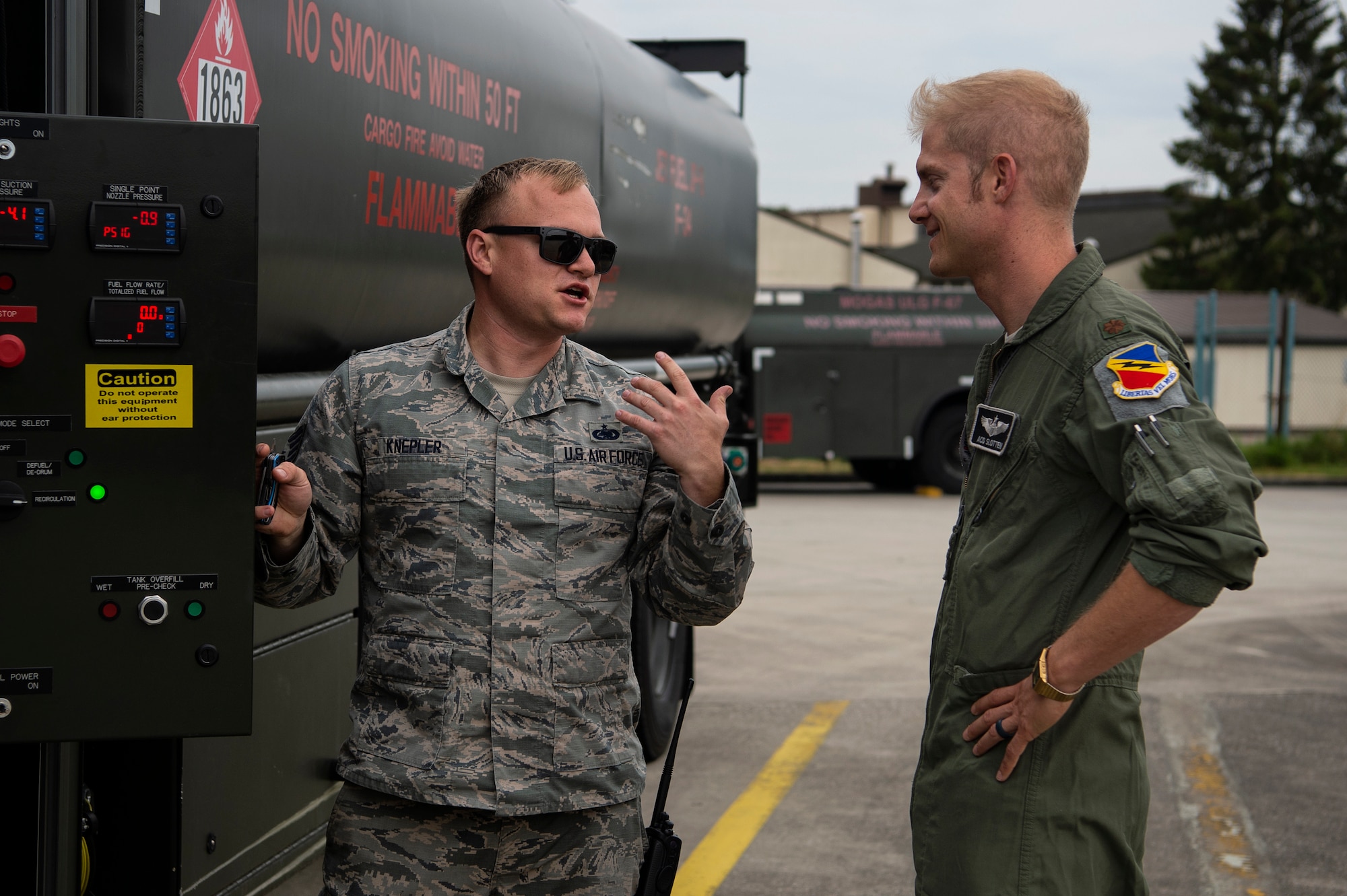 U.S. Air Force Maj. Michael Slotten, 421st Fighter Squadron F-35A Lightning II pilot, right, speaks with Staff Sgt. Jonathan Knepler, 52nd Logistics Readiness Squadron preventive maintenance team NCO in charge, left, at Spangdahlem Air Base, Germany, July 11, 2019. Slotten was stationed at Spangdahlem from 2004 to 2006 as an Airman first class fuels distributor operator. He stopped by his old unit and learned about new changes made since he last operated fuel trucks. (U.S. Air Force photo by Airman 1st Class Valerie Seelye)