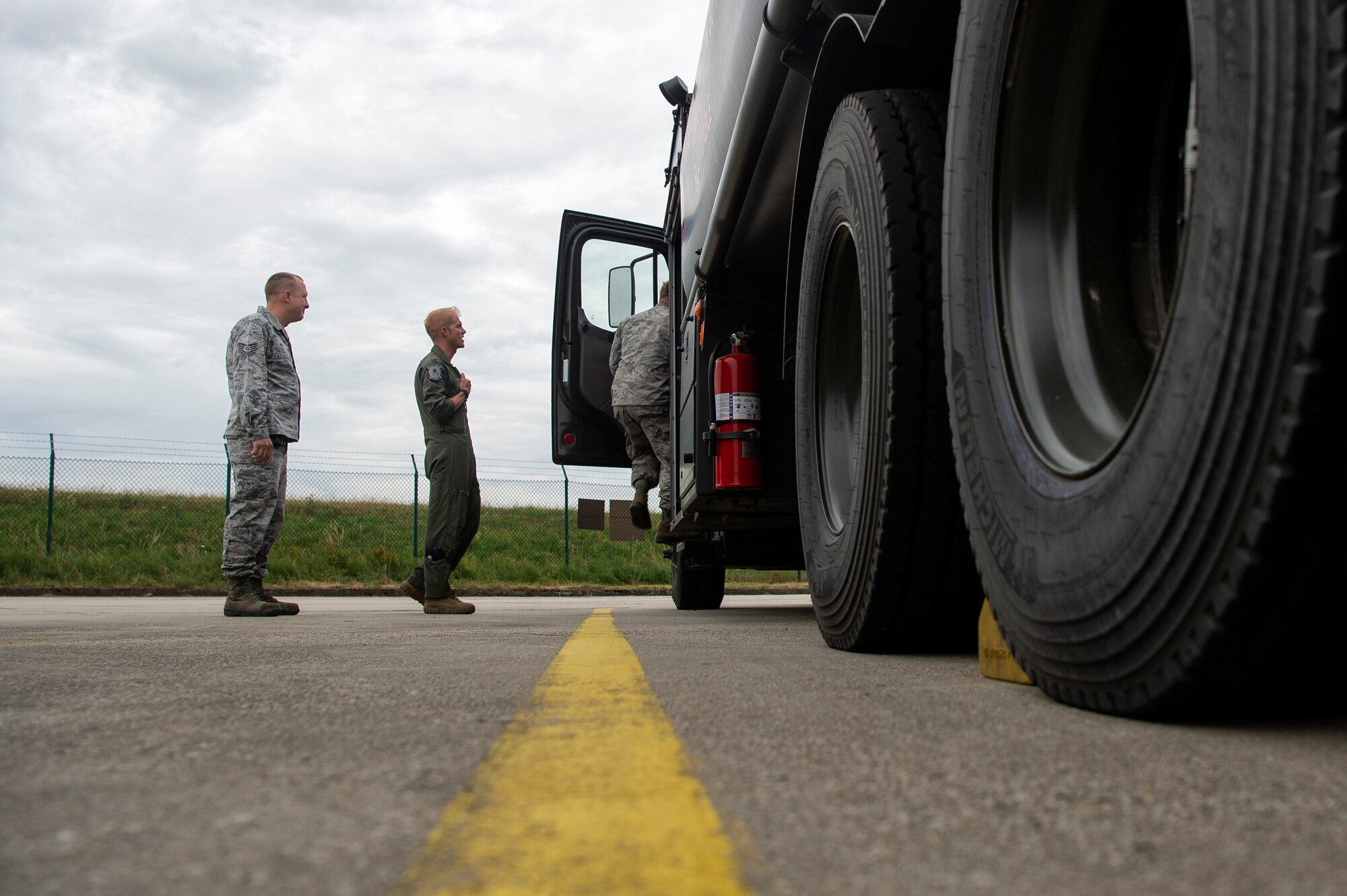 U.S. Air Force Maj. Michael Slotten, 421st Fighter Squadron F-35A Lightning II pilot, center, Tech. Sgt. Charles Moore, 52nd Logistics Readiness Squadron fuels distribution NCO in charge, left, and Staff Sgt. Jonathan Knepler, 52nd LRS preventive maintenance team NCO in charge, right, check out a fuels truck at Spangdahlem Air Base, Germany, July 11, 2019. Slotten was stationed at Spangdahlem from 2004 to 2006 as an Airman first class fuels distributor operator. He visited his old unit and became requalified to refuel aircraft. (U.S. Air Force photo by Airman 1st Class Valerie Seelye)