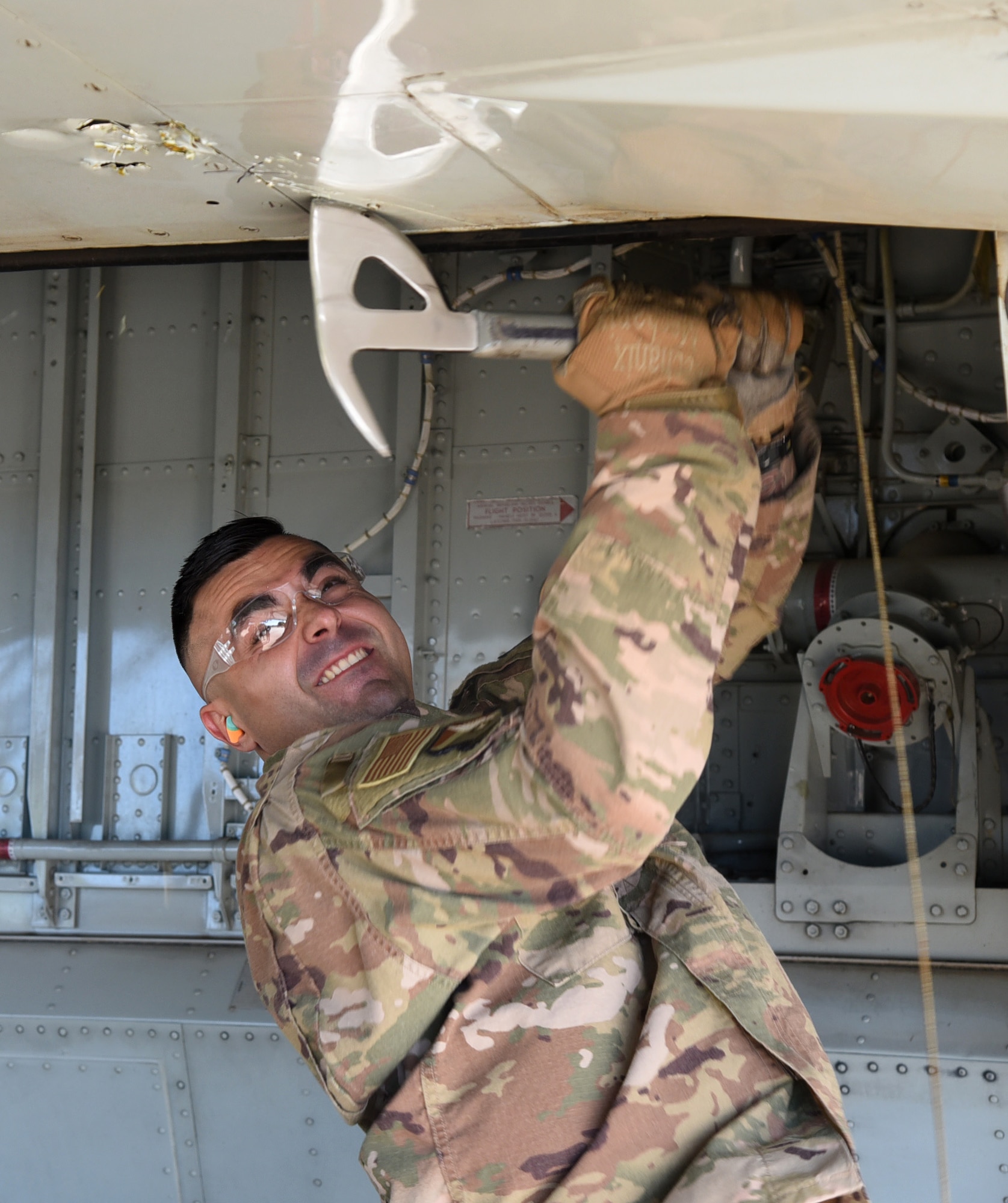 Staff Sgt. Skyler McInnis, an expeditionary depot maintenance craftsman with the 76th Aircraft Maintenance Group, creates the first damage to Speckled Trout, a KC-135 that was once used to transport DV's. (U.S. Air Force photo/Kelly White)