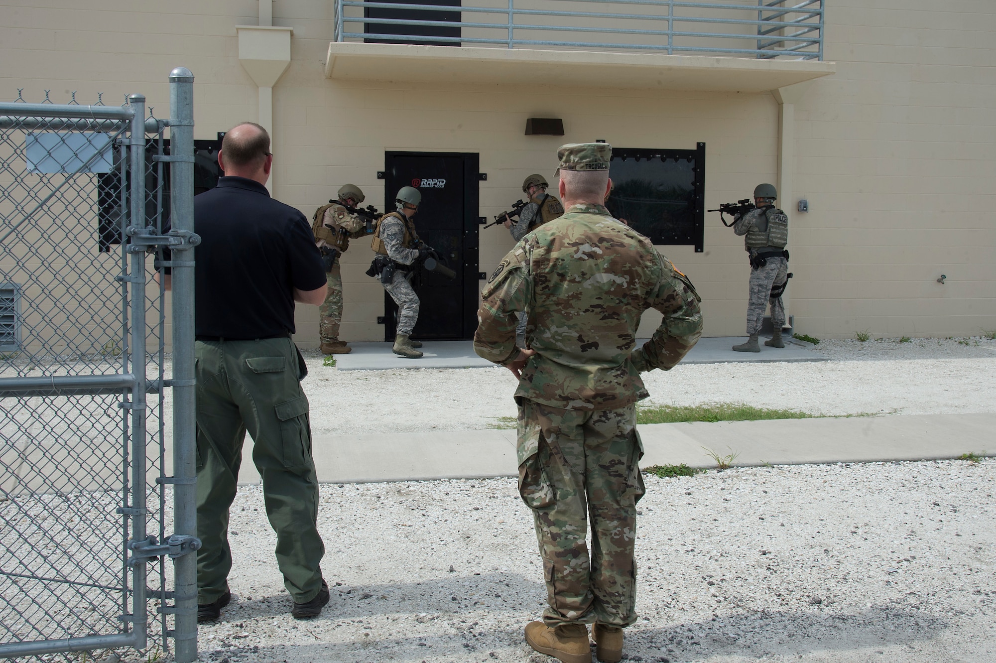 U.S. Army Command Sgt. Maj. John W. Troxell, senior enlisted advisor to the chairman of the Joint Chiefs of Staff, observes a door breach demonstration by members of the 6th Security Forces Squadron, during a MacDill Air Force Base visit, July 11, 2019. During visits to Joint Operational Areas, posts and bases with service members from different branches, the SEAC identifies issues that affect service members, and works to integrate solutions to increase readiness, effectiveness, health, and welfare of the total force. (U.S. Air Force photo by Airman 1st Class Shannon Bowman)