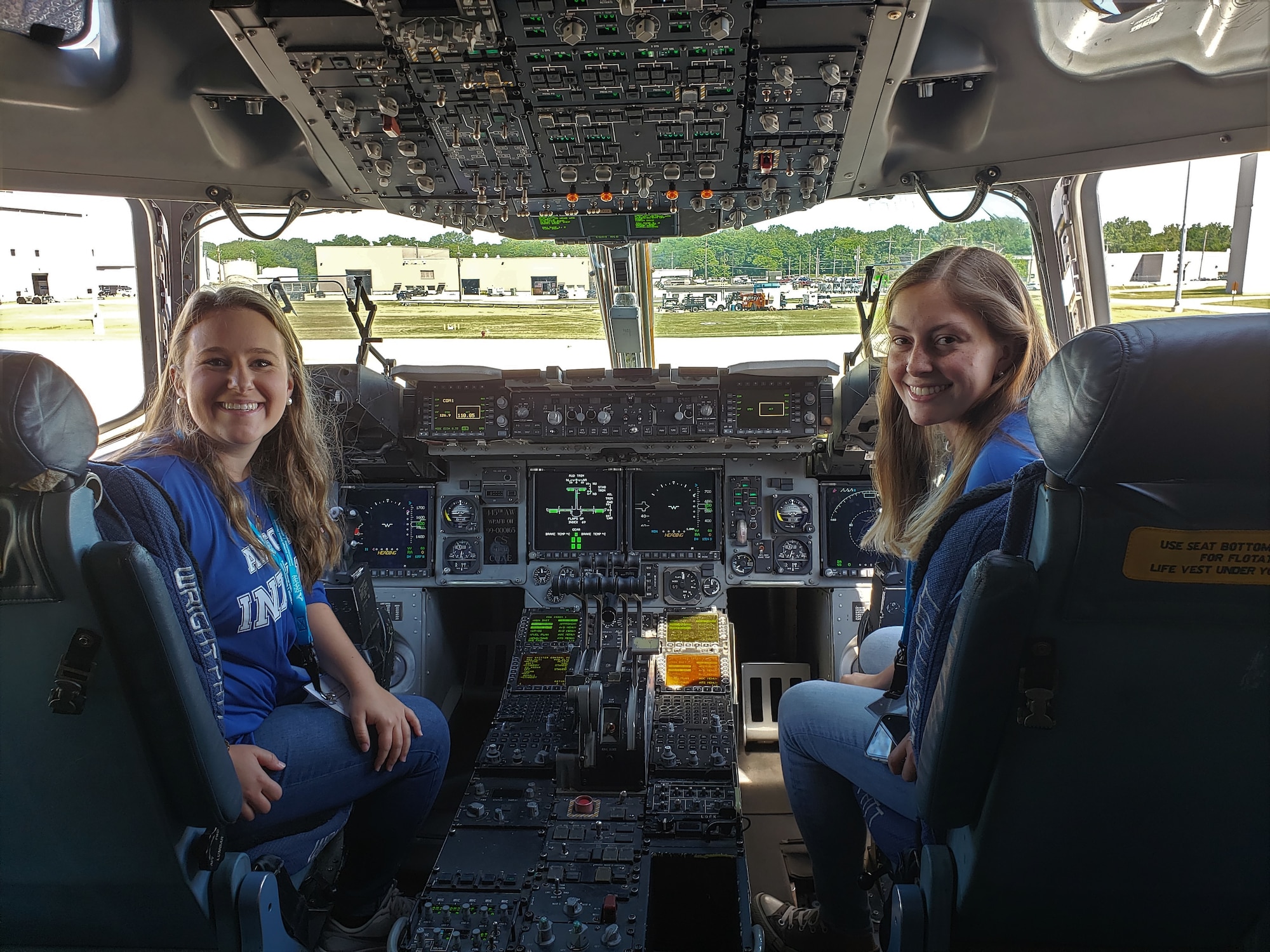 Premier College Intern Program interns Sarah Earnesty and Kayleigh Brown explore the cockpit of a C-17 during part of their three-day symposium at Wright-Patterson Air Force Base. The symposium was hosted by the Air Force Personnel Center at the Holiday Inn in Fairborn, Ohio, June 25-27.  (U.S. Air Force photo/Karina Brady)