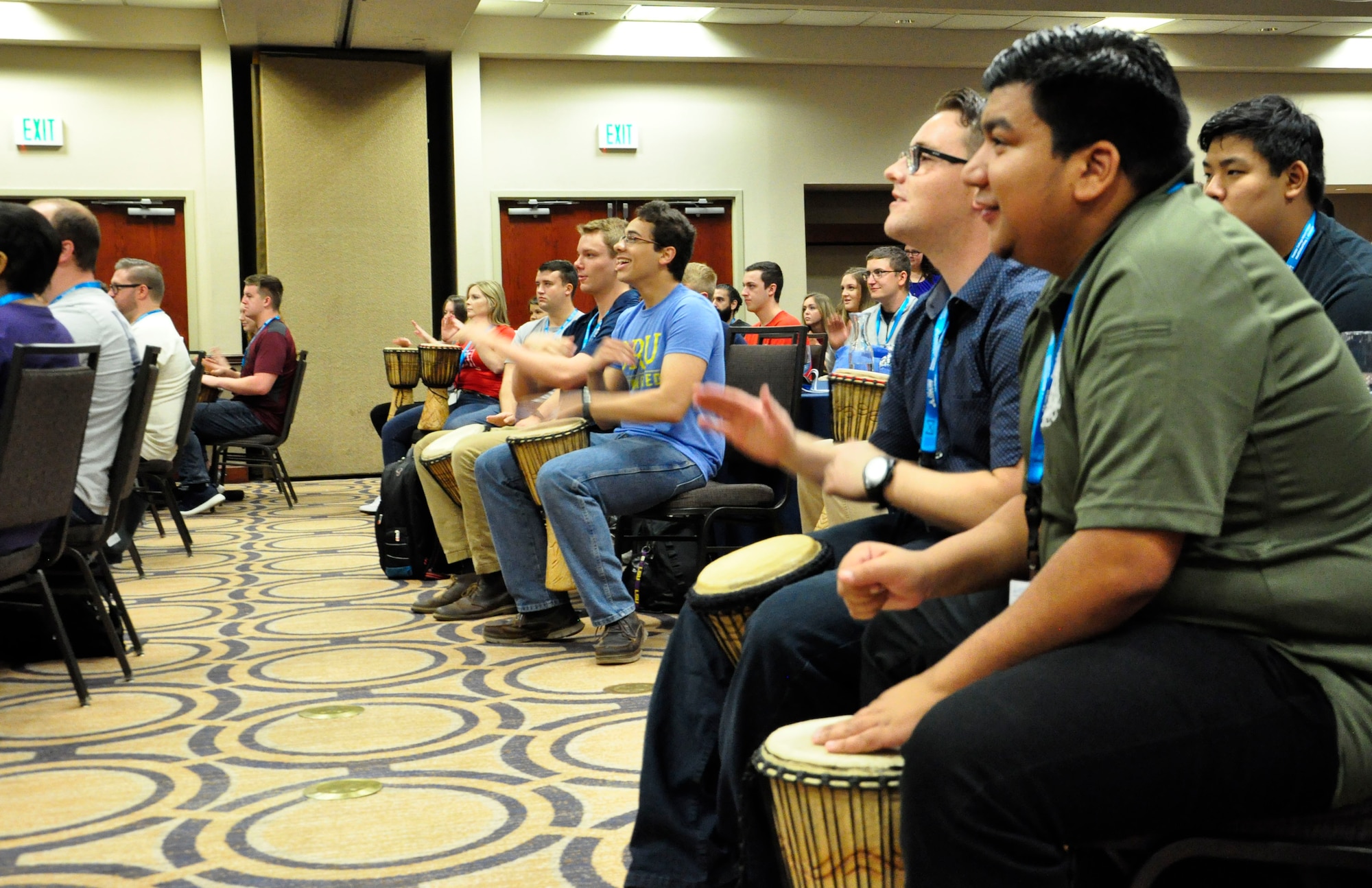 College students in the Air Force’s Premier College Intern Program begin a three-day symposium with the Drum Café, an organization that uses interactive drumming exercises to encourage teamwork and diversity in the workplace. The symposium was hosted by the Air Force Personnel Center at the Holiday Inn in Fairborn, Ohio, June 25-27. (U.S. Air Force photo/Karina Brady)