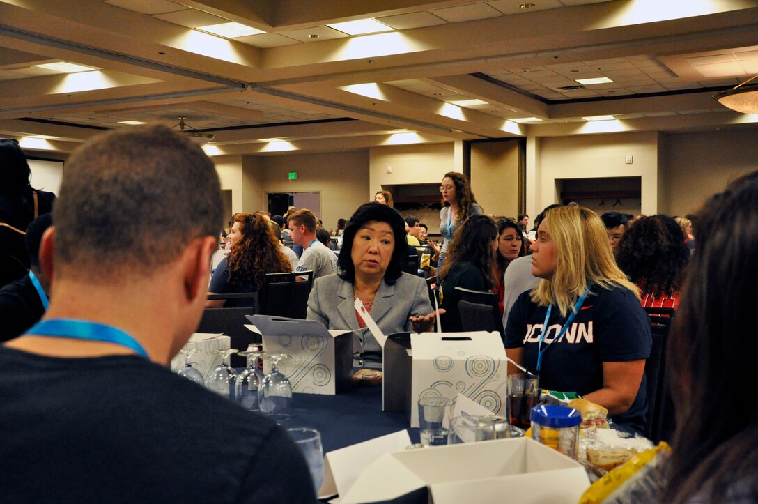 Janet Jackson, Air Force Materiel Command systems engineer division chief, talks with a group of engineering interns during a mentoring lunch at the Premier College Intern Program symposium. The symposium was hosted by the Air Force Personnel Center at the Holiday Inn in Fairborn, Ohio, June 25-27.(U.S. Air Force photo/Karina Brady)