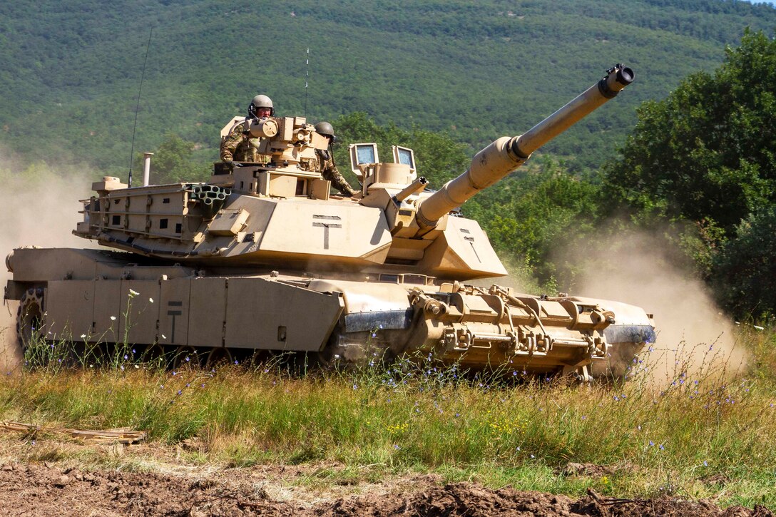 An abrams tank maneuvers across a field.