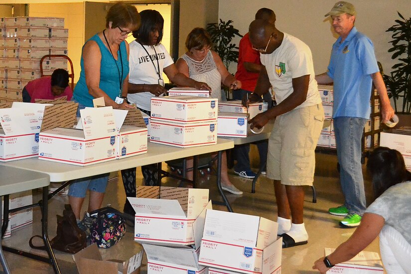 U.S. Army Financial Management Command, Defense Finance and Accounting Service and Army Human Resources Command Soldiers and civilian employees pack care packages at the Maj. Gen. Emmett J. Bean Federal Center, Indianapolis, June 29, 2019. The volunteers spent their off-duty time to package and help ship more than 200 care packages to financial management service members currently deployed in Southwest Asia. (U.S. Army courtesy photo provided by Mark Sullivan, U.S. Army Financial Management Command)