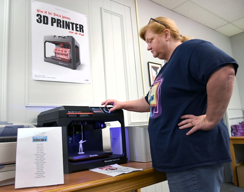 Carla Tubby, a library technician with the 72nd Force Support Squadron, adjusts the settings on the Tinker Library's new 3D printer which is available for use during normal library hours. For more information or to make an appointment to use the printer, please call (405)734-2626. (U.S. Air Force photo/Kelly White)
