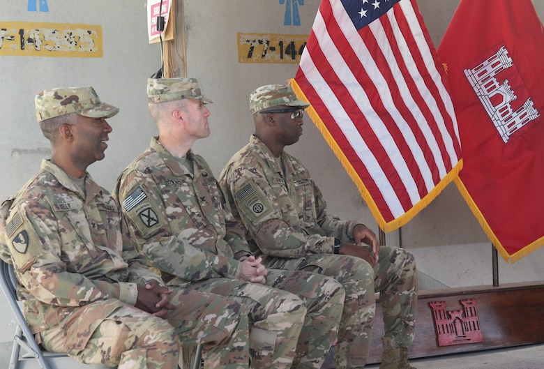 Col. Jason E. Kelly, Outgoing Afghanistan District Commander, Col. Chris Becking, Incoming Afghanistan District Commander, and Command Sgt. Maj. Nate Atkinson, Outgoing Senior Enlisted Advisor embracing the July 15, 2019 Change of Command Ceremony at Bagram, Airfield.