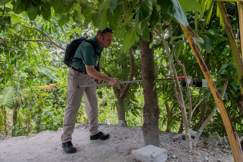 U.S. Army Capt. Patrick McClellan, Joint Task Force – Bravo Medical Element entomologist, vacuums insects that could serve as disease vectors during a Leishmaniasis investigation July 9, 2019, at La Libertad, Honduras. Members of JTF-B were asked by the Honduran Ministry of Health to conduct an investigation into the cause of Leishmaniasis and provide any recommendations that may stop infection. Leishmaniasis is a parasitic disease that is caused by infection with leishmania parasites, which are spread through the bite of sand flies. (U.S. Air Force photo by Staff Sgt. Eric Summers Jr.)
