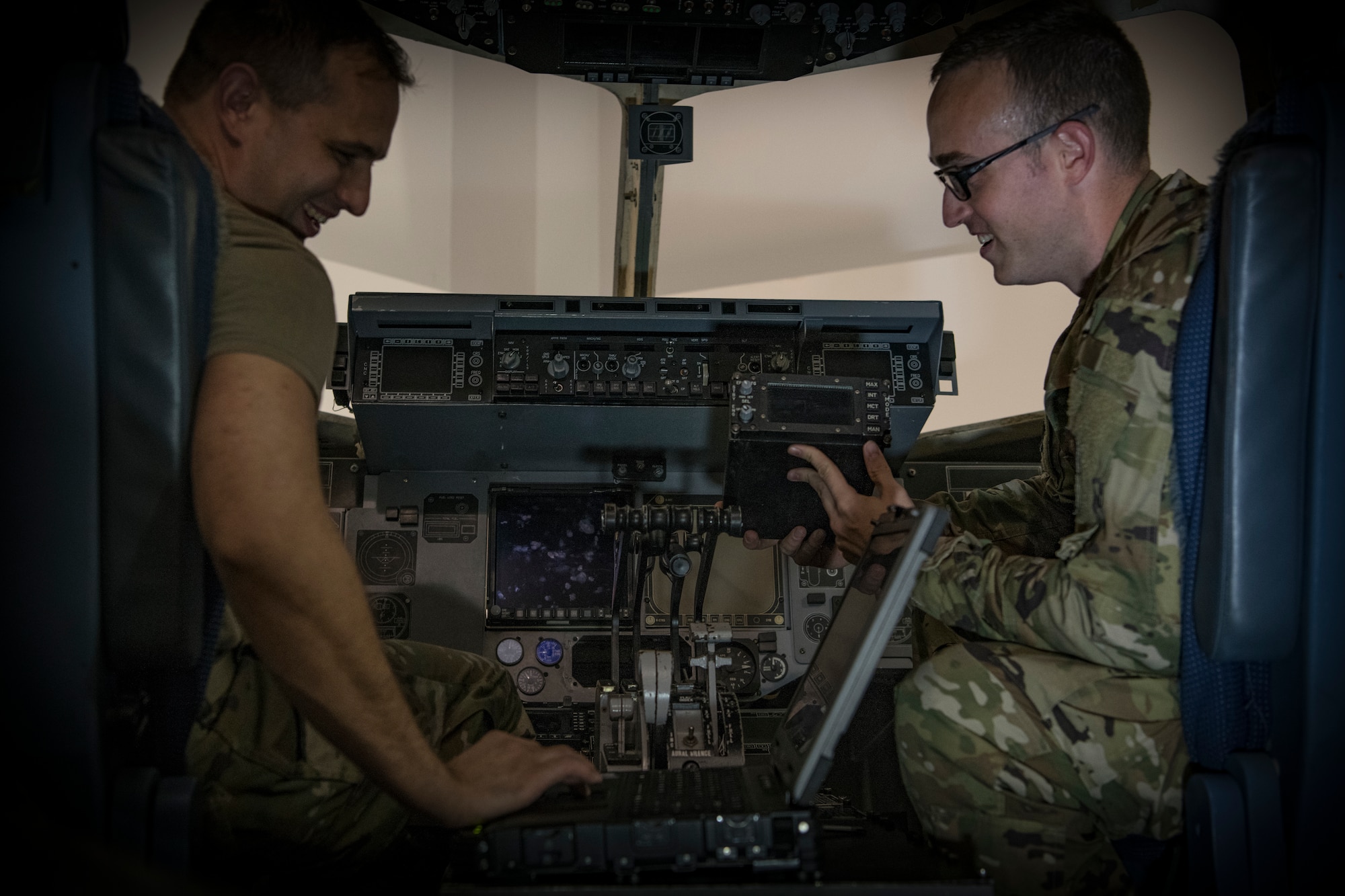 Tech. Sgts. Richard Lundrgen, left, and Kyle Busby work to install cockpit avionics in a maintenance simulator July 1, 2019, at Detachment 5 training facility, Joint Base Charleston, S.C. Detachment 5 utilizes a 44,000 square foot maintenance training facility to safely and effectively train Mobility Airmen throughout the Air Force on maintenance and repair procedures. The instructor team provides over 20,000 hours of instruction per year to new and seasoned avionic maintainers of the U.S. and partnered militaries who also utilize similar airframes. The Airmen are trained on innovative simulators in a safety oriented environment to maximize their effectiveness on the flightline. The C-17 Maintenance Trainer Development Team is comprised of training instructors from multiple Air Force Specialty Codes who fill the role as subject matter experts for the development of maintenance Airmen.
