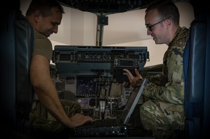 Tech. Sgts. Richard Lundrgen, left, and Kyle Busby work to install cockpit avionics in a maintenance simulator July 1, 2019, at Detachment 5 training facility, Joint Base Charleston, S.C. Detachment 5 utilizes a 44,000 square foot maintenance training facility to safely and effectively train Mobility Airmen throughout the Air Force on maintenance and repair procedures. The instructor team provides over 20,000 hours of instruction per year to new and seasoned avionic maintainers of the U.S. and partnered militaries who also utilize similar airframes. The Airmen are trained on innovative simulators in a safety oriented environment to maximize their effectiveness on the flightline. The C-17 Maintenance Trainer Development Team is comprised of training instructors from multiple Air Force Specialty Codes who fill the role as subject matter experts for the development of maintenance Airmen.