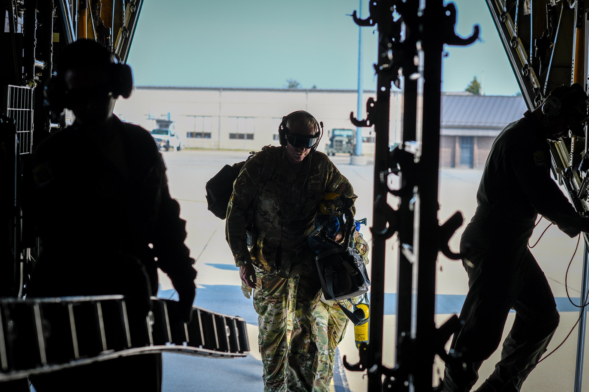 A Reserve Citizen Airman with the 445th Aeromedical Evacuation Squadron walks aboard a Youngstown Air Reserve Station C-130H Hercules on July 10, 2019, on the flightline at Wright-Patterson Air Force Base.