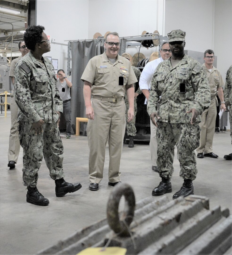 EMC AnnMarie Allison (left) and EM1 Jasmin McDowell explain to Rear Adm. Tom Anderson (center) the Intermediate Level maintenance capabilities of the Outside Machine Shop at Southeast Regional Maintenance Center.