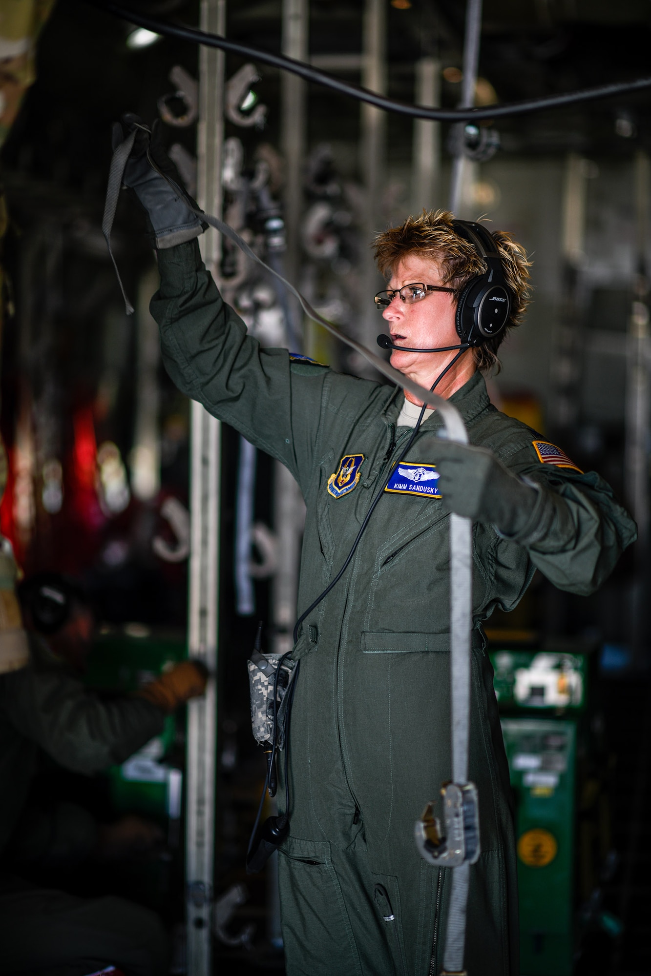 Lt. Col. Kimm Sandusky, a Reserve Citizen Airman with the 445th Aeromedical Evacuation Squadron, extends cargo straps aboard a Youngstown Air Reserve Station C-130H Hercules on July 10, 2019, on the flightline at Wright-Patterson Air Force Base.