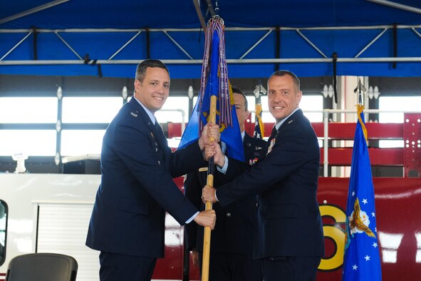 Col. Edward Marshall, 45th Mission Support Group commander, presents Lt. Col. Joshua Connell, incoming 45th Civil Engineering Squadron commander, with the 45th CES guidon as he assumes command of the group. (U.S. Air Force photo by Amanda Ryrholm)