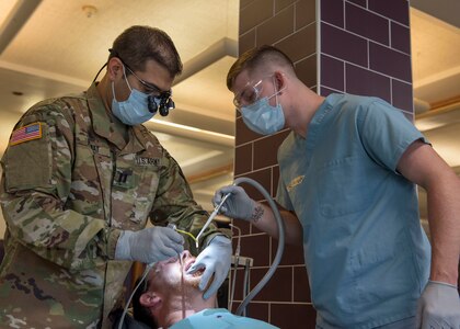 Dentists provide no-cost care while operating in field conditions