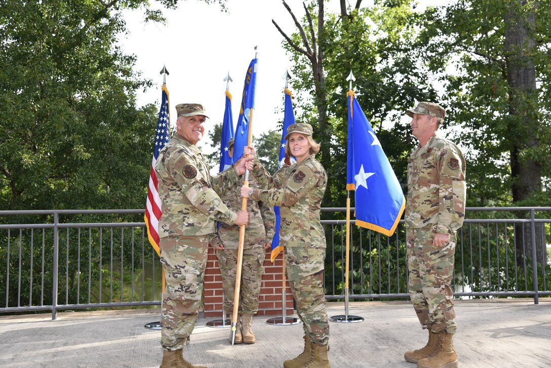 Maj. Gen. John “Jay” Flournoy Jr. passes the guidon to Brig. Gen. Stacey L. Scarisbrick suring a change of command ceremony on Robins Air Force Base in Georgia on July 15. Scarisbrick takes command of the Air Force Reserve Command Force Generation Center relieving Brig. Gen. Matthew J. Burger. (U.S. Air Force photo by Misuzu Allen)