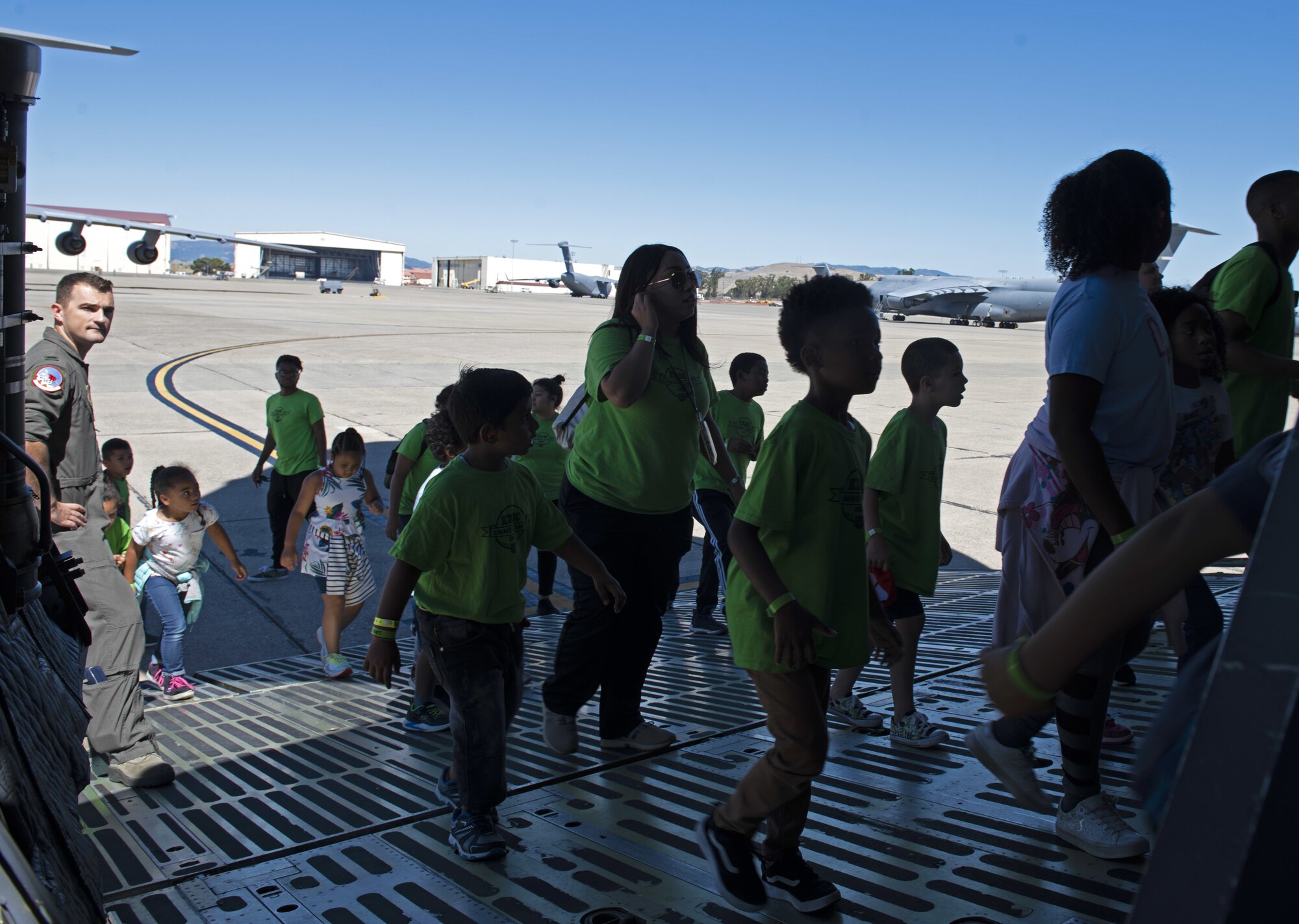 Children from the Suisun City Salvation Army Kroc Center summer camp walk onto a C-5M Super Galaxy July 11, 2019, at Travis Air Force Base, California. This tour gave members of the local community the chance to see what Airmen assigned to the 22nd AS do on a daily basis. (U.S. Air Force photo by Senior Airman Jonathon Carnell)