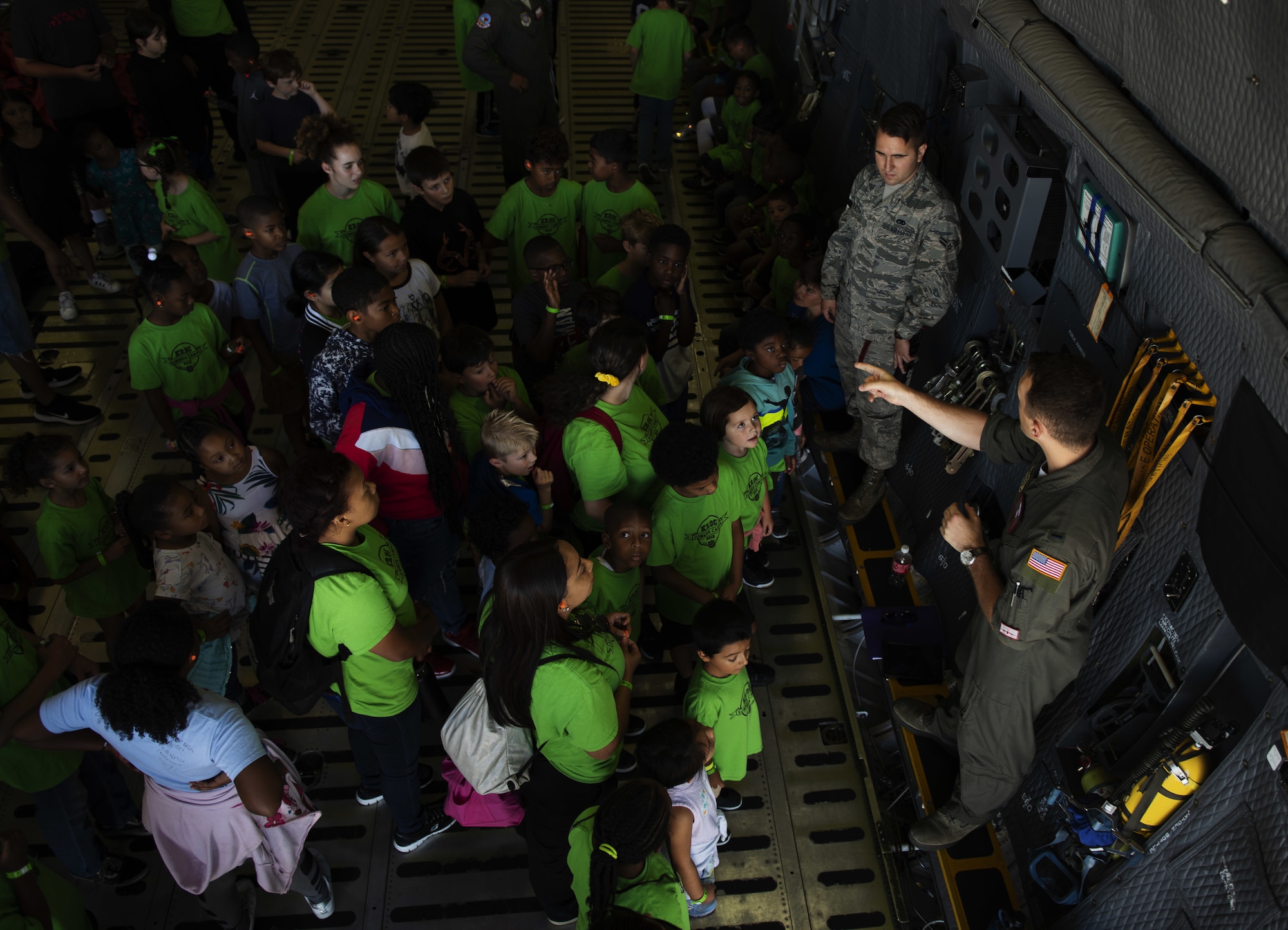 U.S. Air Force 1st Lt. Alex Crandell, 22nd Airlift Squadron C-5M Super Galaxy pilot, describes the aircraft’s mission to children from the Suisun City Salvation Army Kroc Center summer camp July 11, 2019, at Travis Air Force Base, California. This tour gave members of the local community the chance to see what Airmen assigned to the 22nd AS do on a daily basis. (U.S. Air Force photo by Senior Airman Jonathon Carnell)