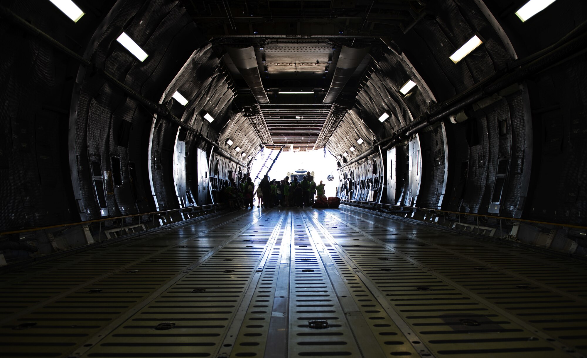 U.S. Air Force Airmen from the 22nd Airlift Squadron, describe the C-5M Super Galaxy mission to children from the Suisun City Salvation Army Kroc Center summer camp July 11, 2019, at Travis Air Force Base, California. This tour gave members of the local community the chance to see what Airmen assigned to the 22nd AS do on a daily basis. (U.S. Air Force photo by Senior Airman Jonathon Carnell)