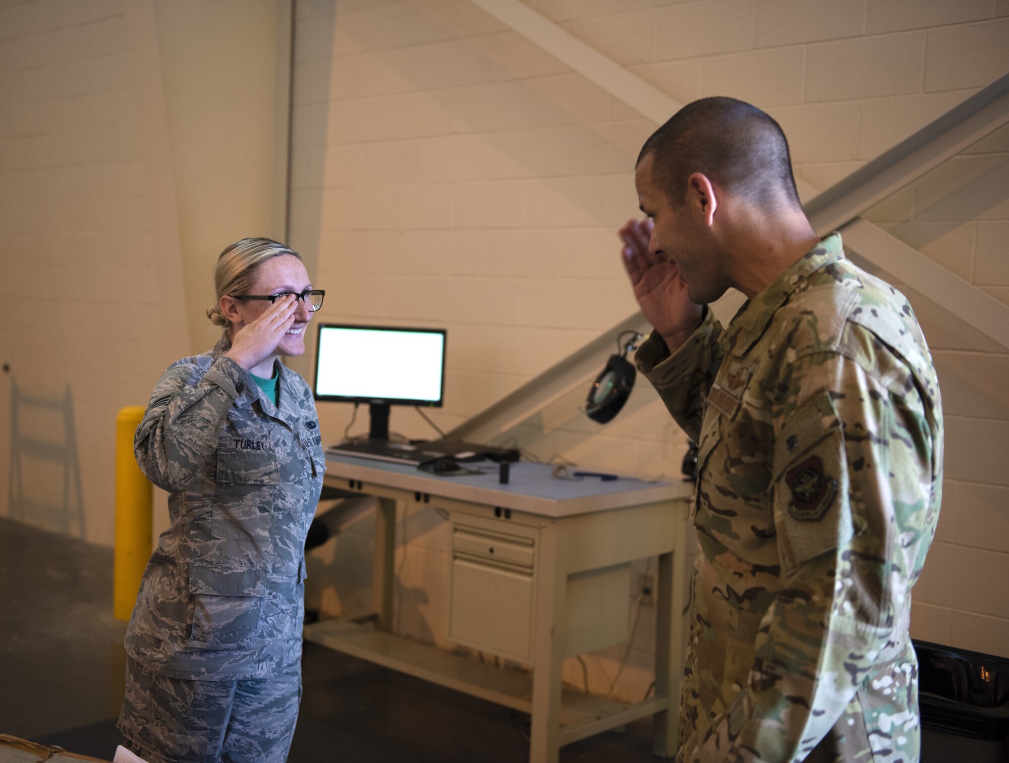 U.S. Air Force Senior Airman Mikaela Turley, left, salutes Col. Zachery Jiron, 60th Air Mobility Wing vice commander, after receiving a coin July 12, 2019, at Travis Air Force Base, California. Jiron went to the LRS for Leadership Rounds, a program that allows wing leadership to get a detailed view of their mission at Travis Air Force Base. (U.S. Air Force photo by Senior Airman Jonathon Carnell)
