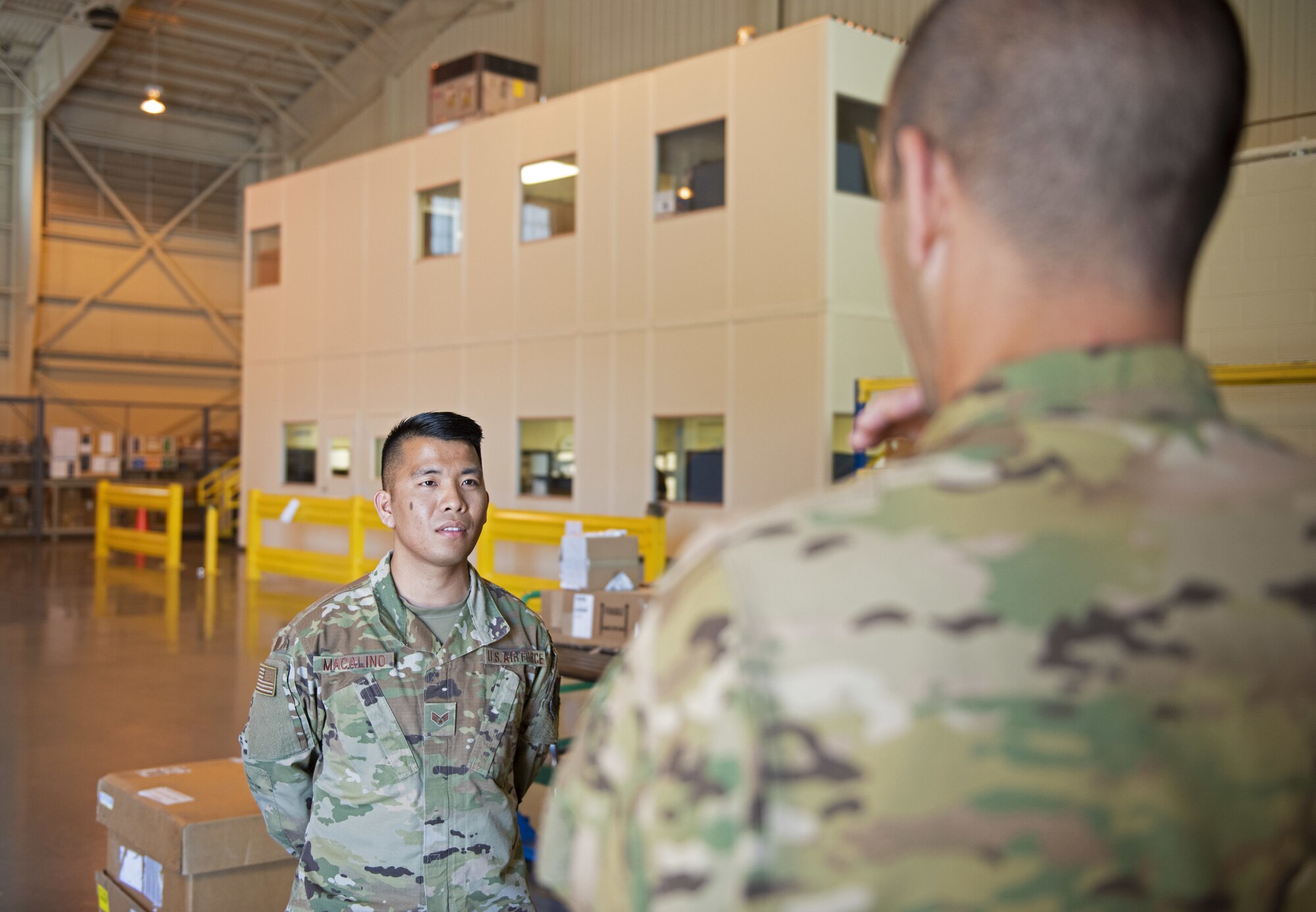 U.S. Air Force Senior Airman Jerome Macalino, left, 60th Logistics Readiness Squadron service center journeyman, left, speaks about his job to Col. Zachery Jiron, 60th Air Mobility Wing vice commander, July 12, 2019, at Travis Air Force Base, California. Jiron went to the LRS for Leadership Rounds, a program that allows wing leadership to get a detailed view of their mission at Travis Air Force Base. (U.S. Air Force photo by Senior Airman Jonathon Carnell)